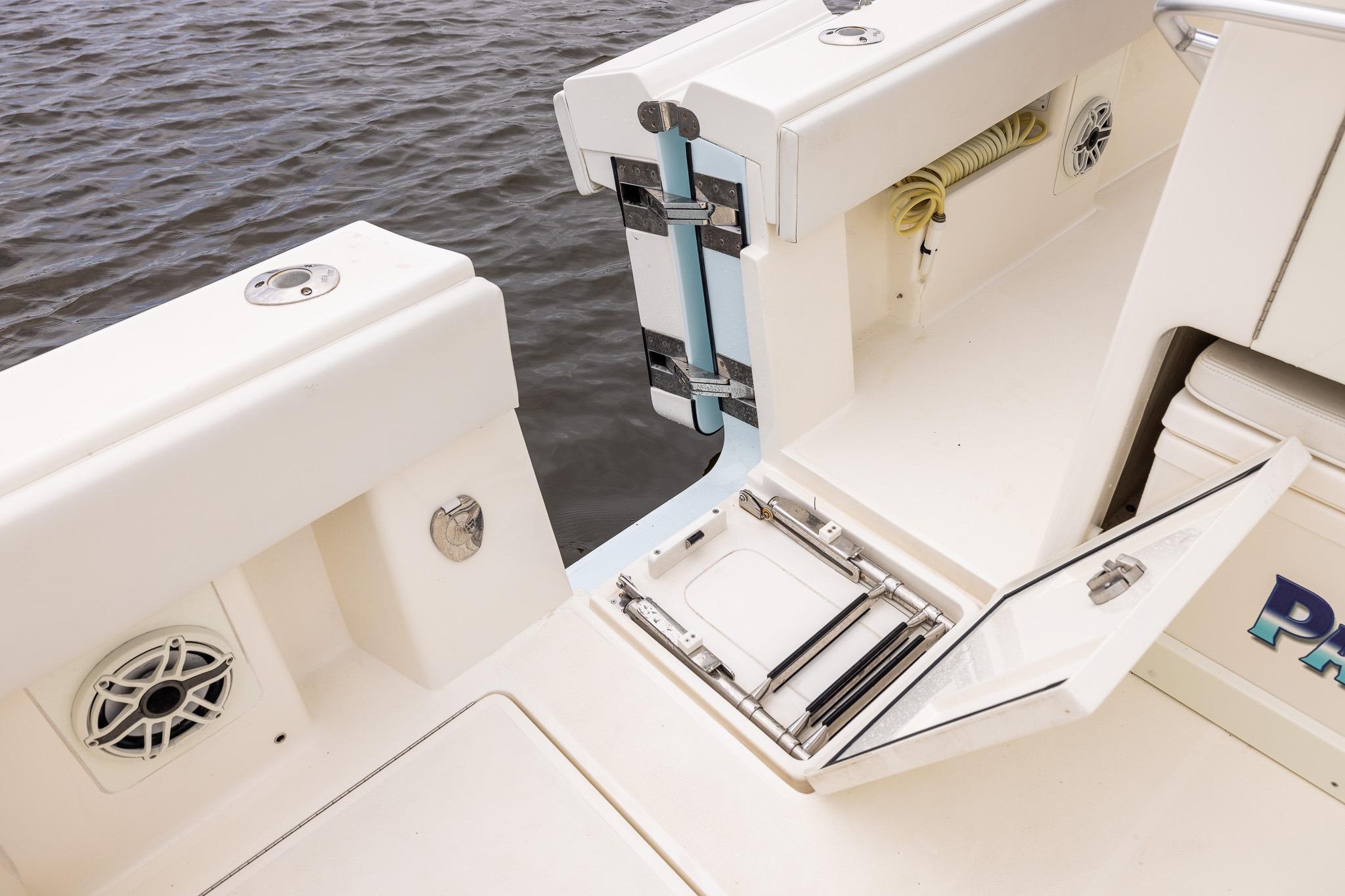 2019 SeaVee 322Z boat deck with storage compartment and speaker, docked on water.