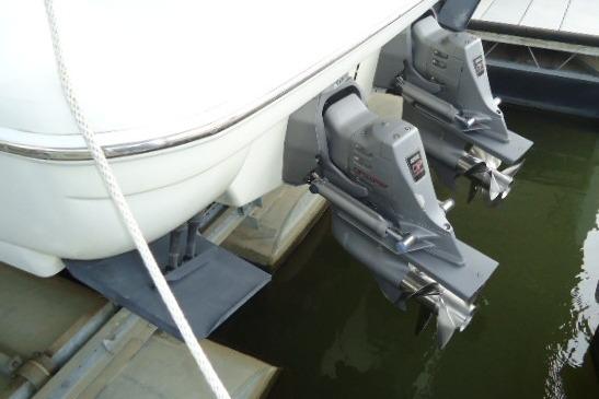 1999 Formula 400 Super Sport boat with dual outboard motors docked in water.