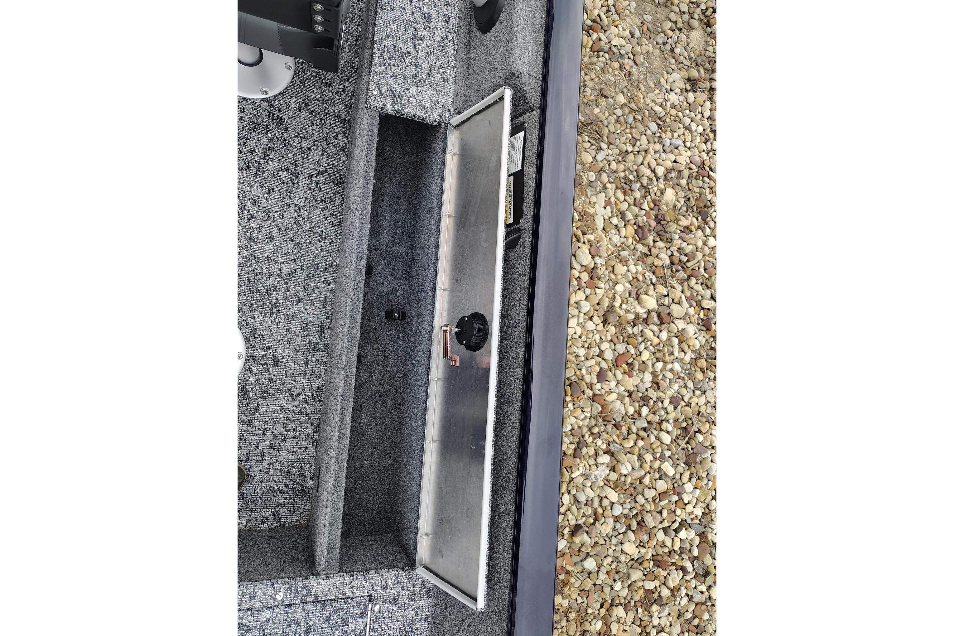 Interior view of 2026 Tracker Pro Guide V-16 SC boat with open storage compartment.