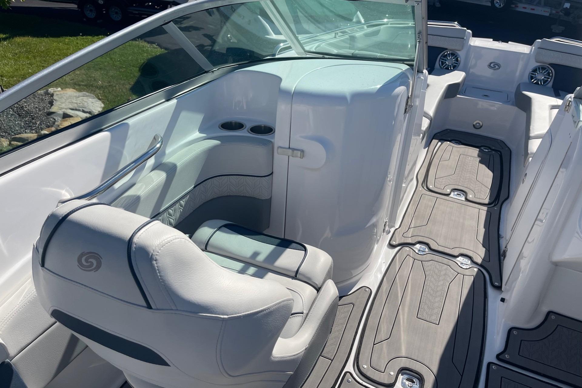 2023 Hurricane SunDeck 2400 OB boat interior with seating and cup holders.