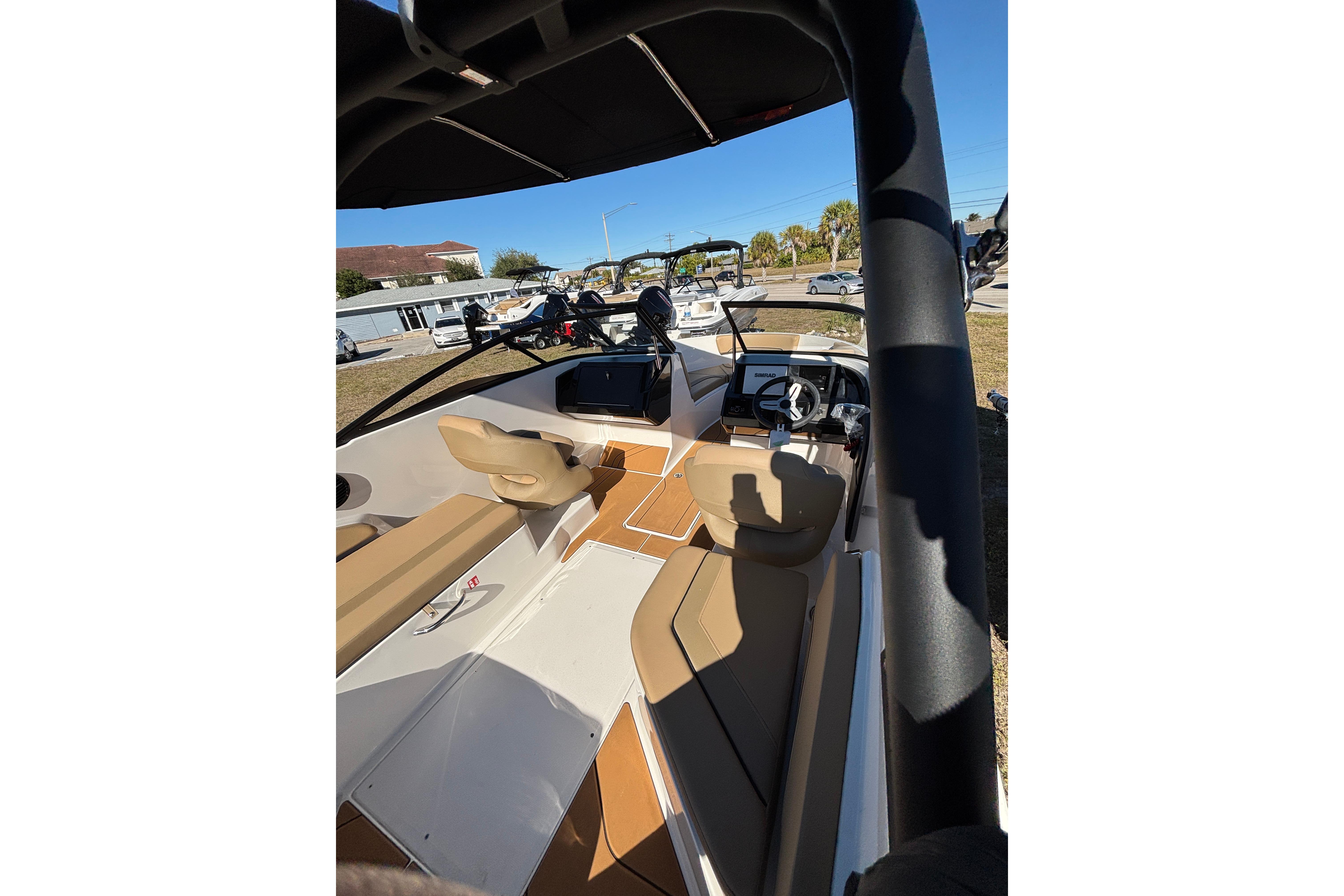 2025 Bayliner V20 boat interior with tan seating and modern dashboard.