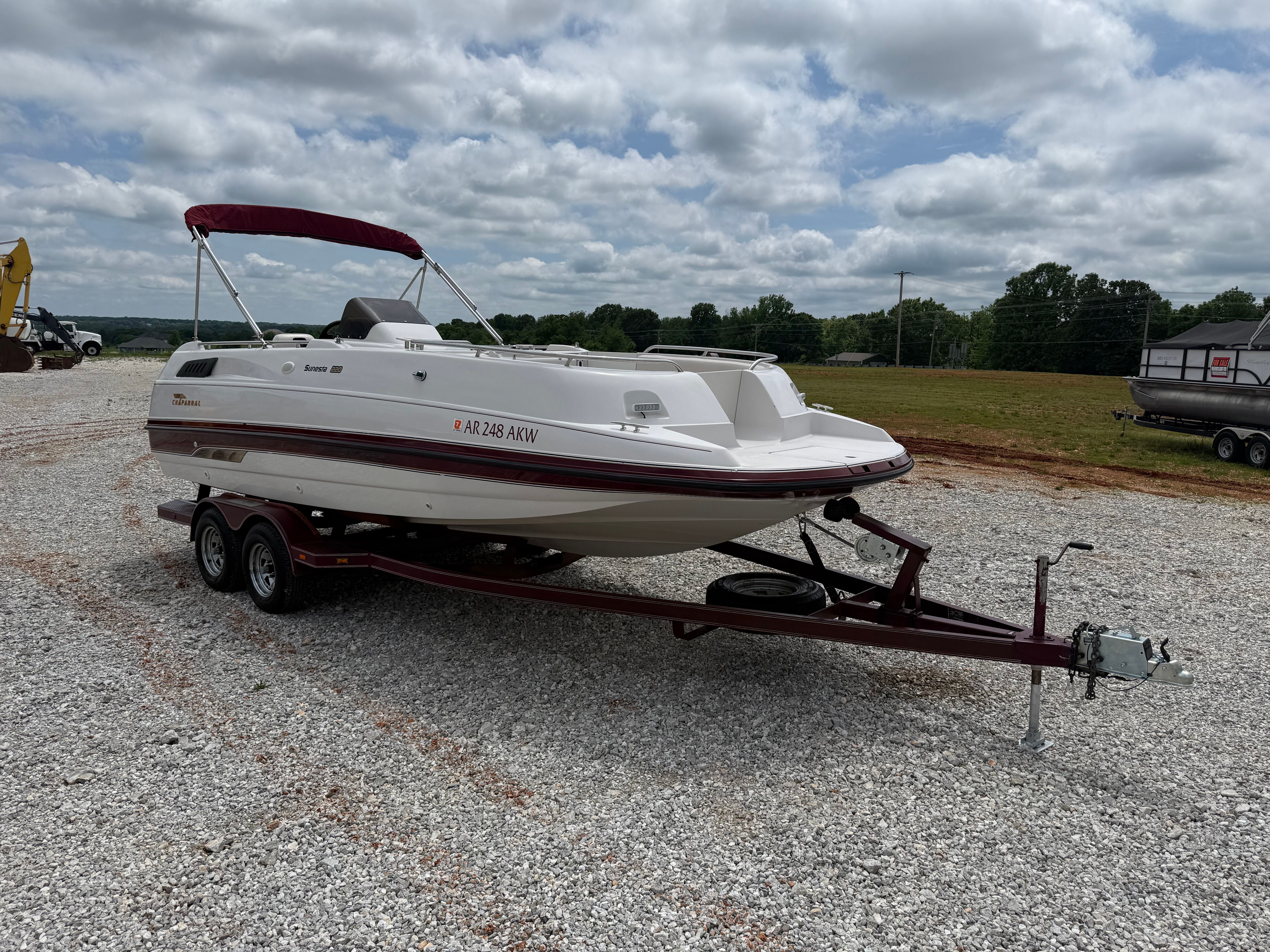 A 1994 Chaparral Sunesta 220 on a trailer in a gravel lot.