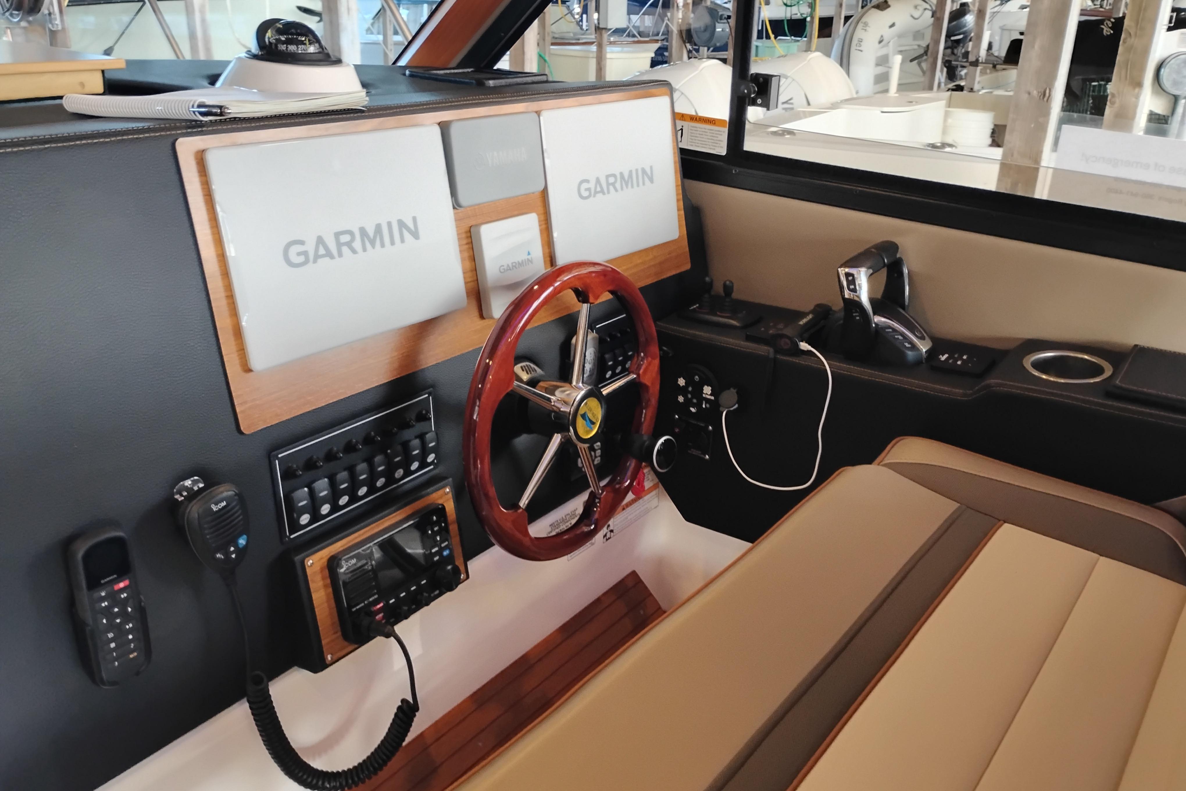 2022 Cutwater C-32 Coupe helm with Garmin navigation, wood accents, and modern controls.