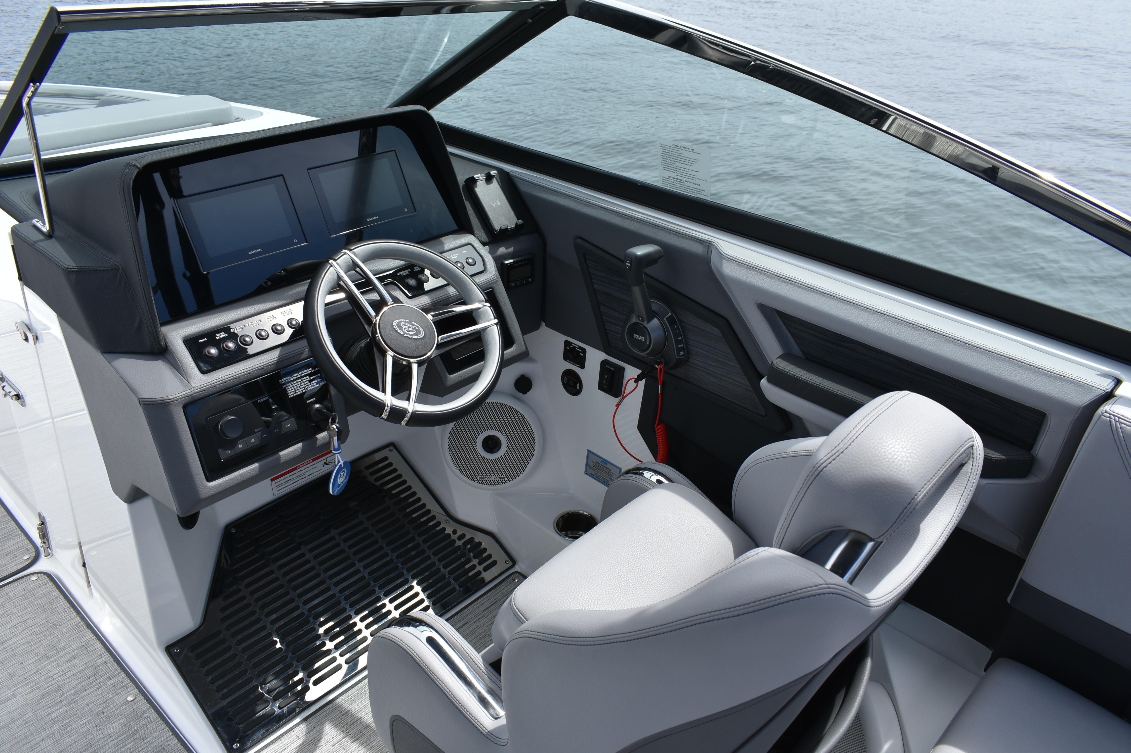 2023 Cobalt R8 boat cockpit with modern steering and control panel on the water.