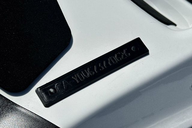 Close-up of a black plaque on a white surface.