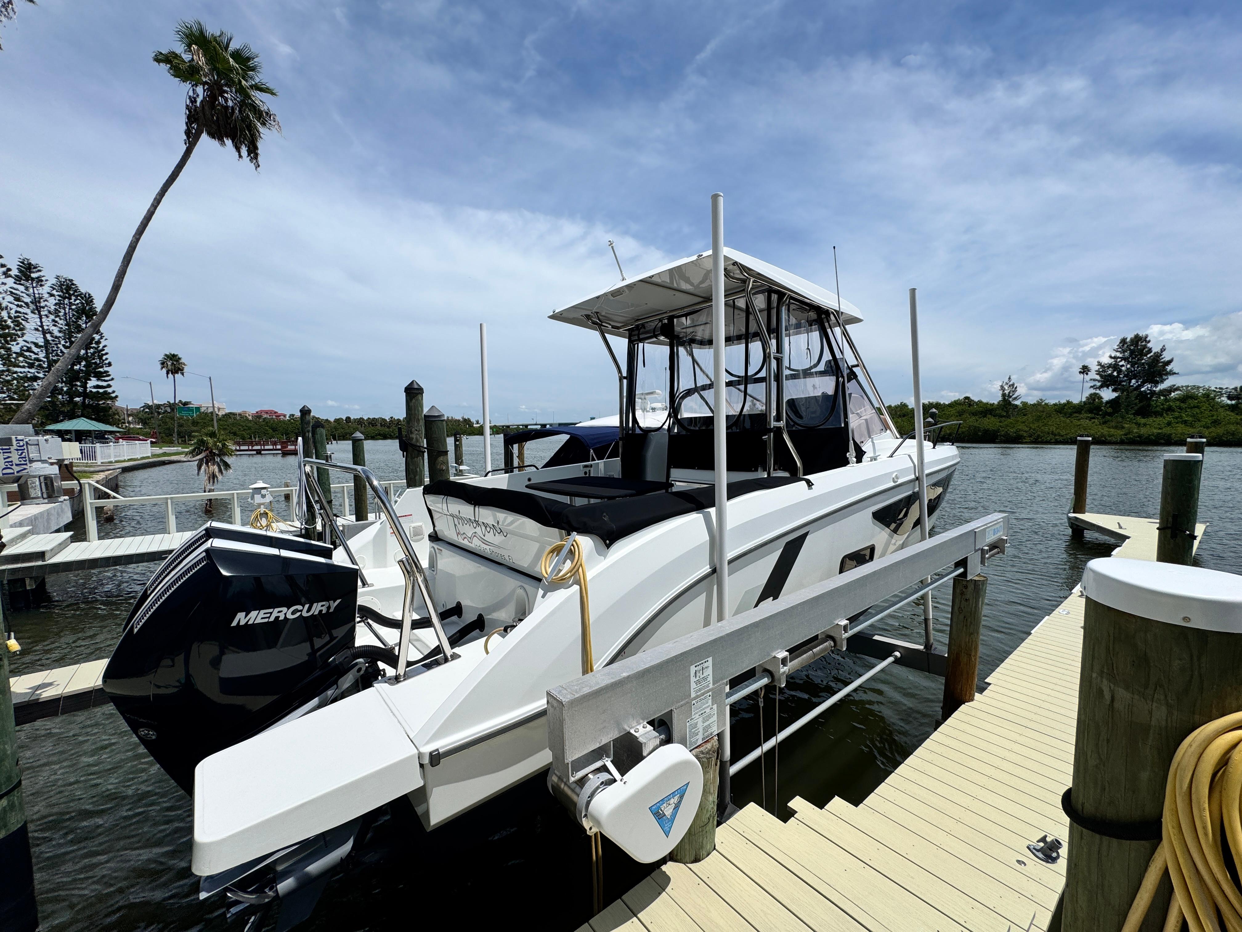 2022 Beneteau Flyer 9 SUNdeck docked, featuring a Mercury engine, under a clear blue sky.