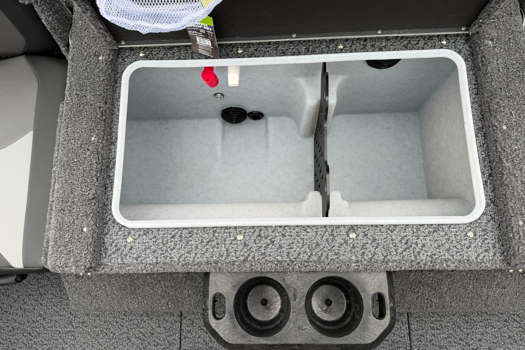 Livewell compartment in 2027 Lund 2075 Impact XS boat, featuring dual sections and cup holders.
