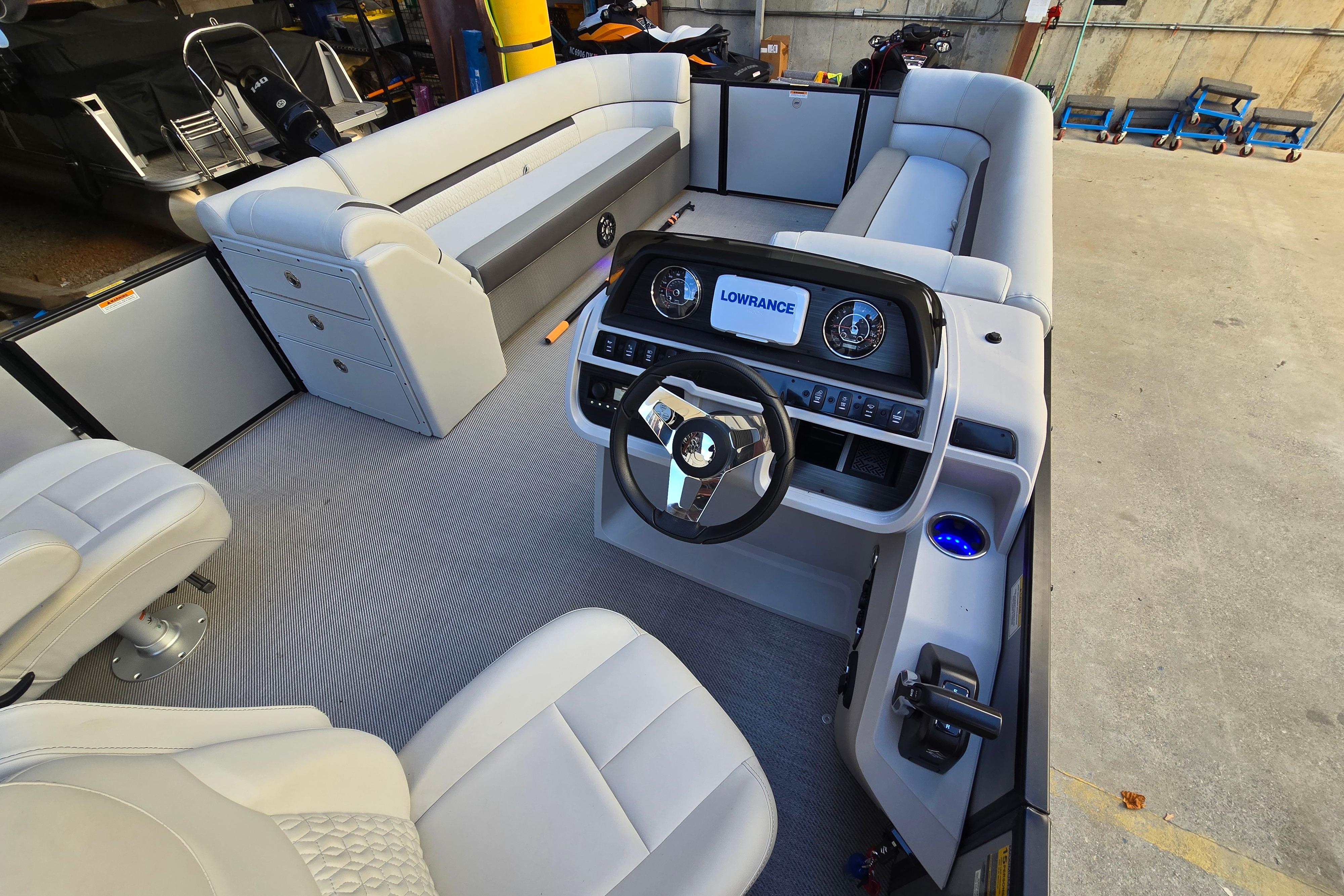Interior of 2024 Godfrey Sweetwater 2486 SB pontoon boat with modern helm and seating.
