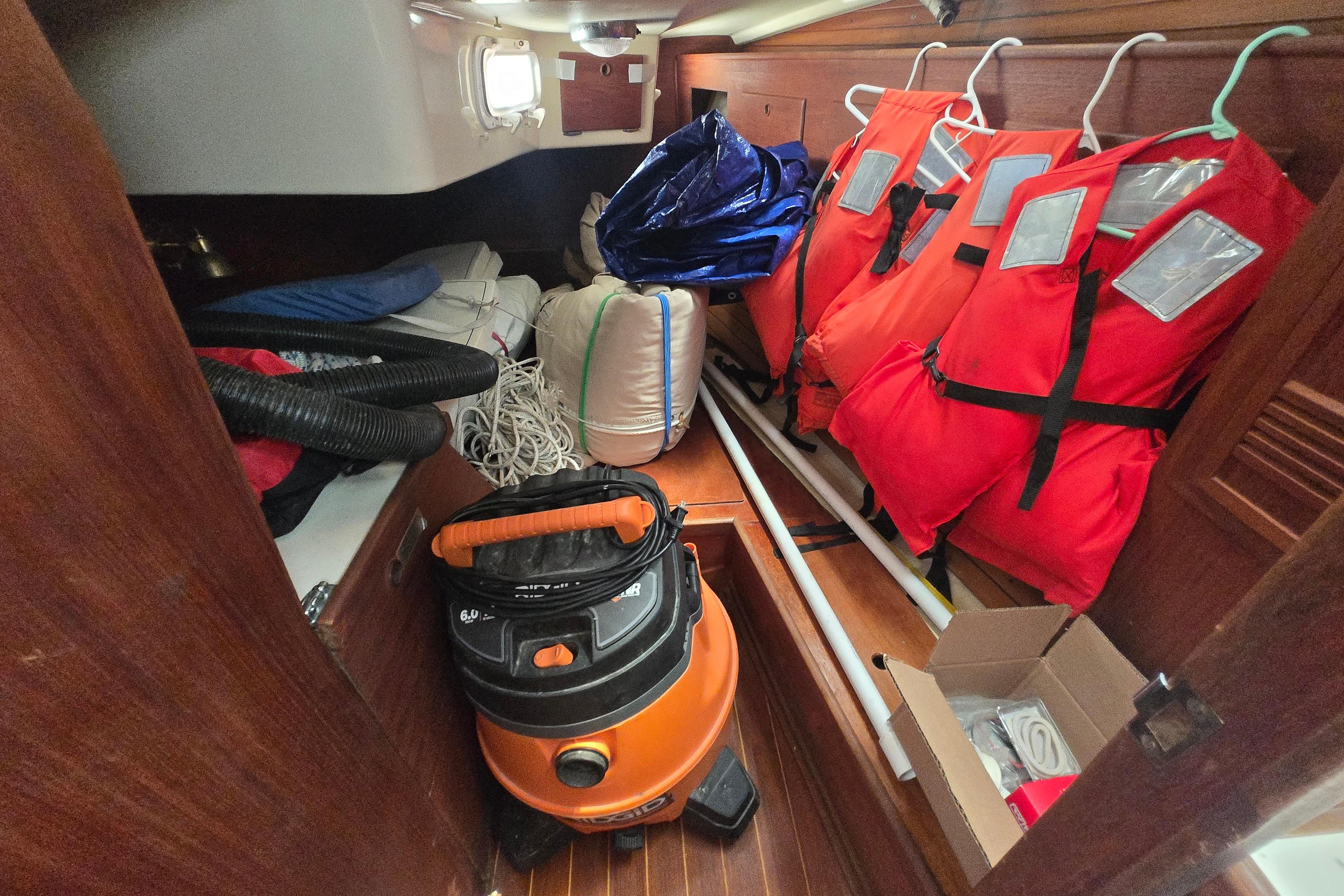 Storage area in a 1988 Sabre 38 sailboat with life jackets and equipment.