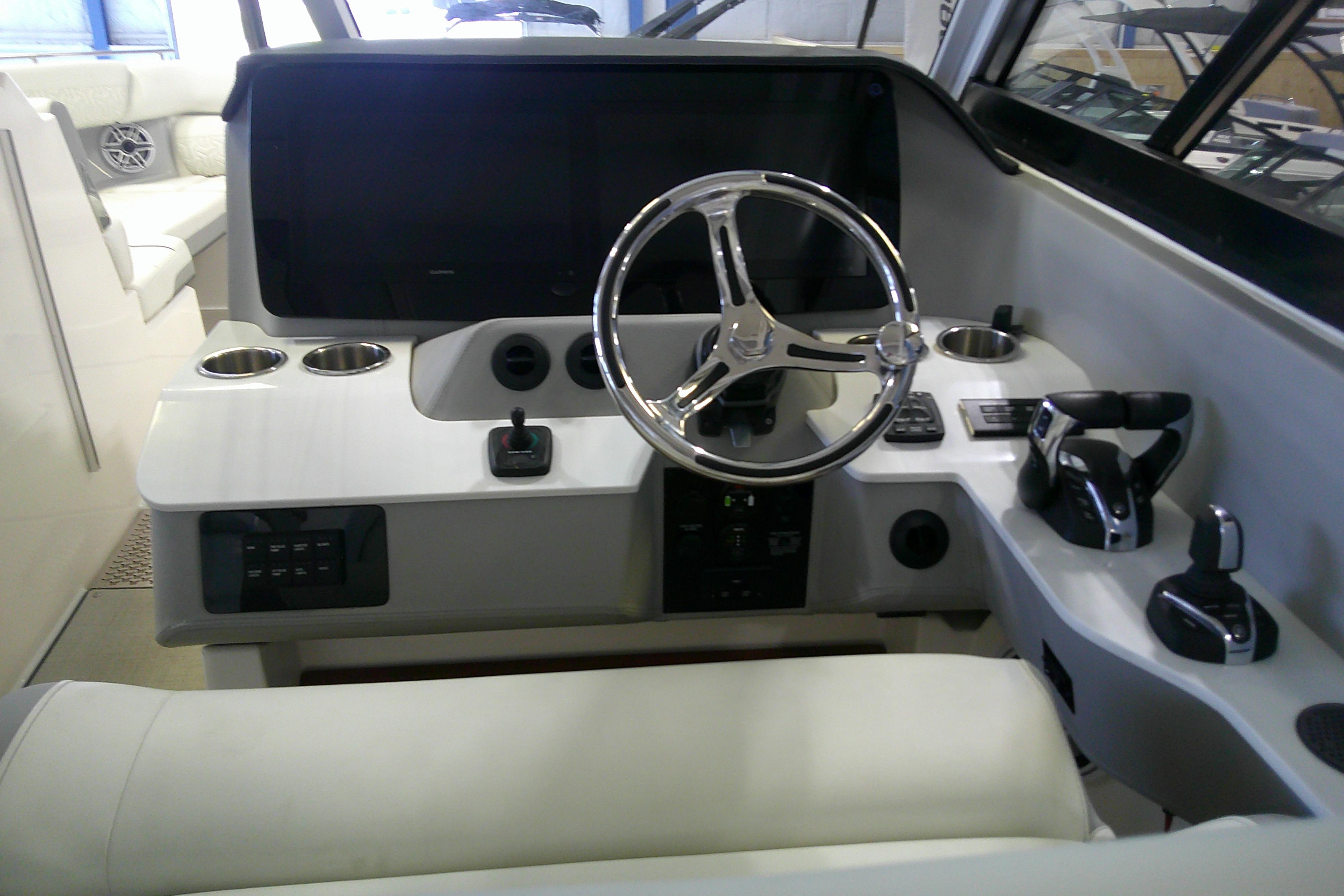 2023 Regal LX36 boat helm with modern controls and sleek steering wheel design.