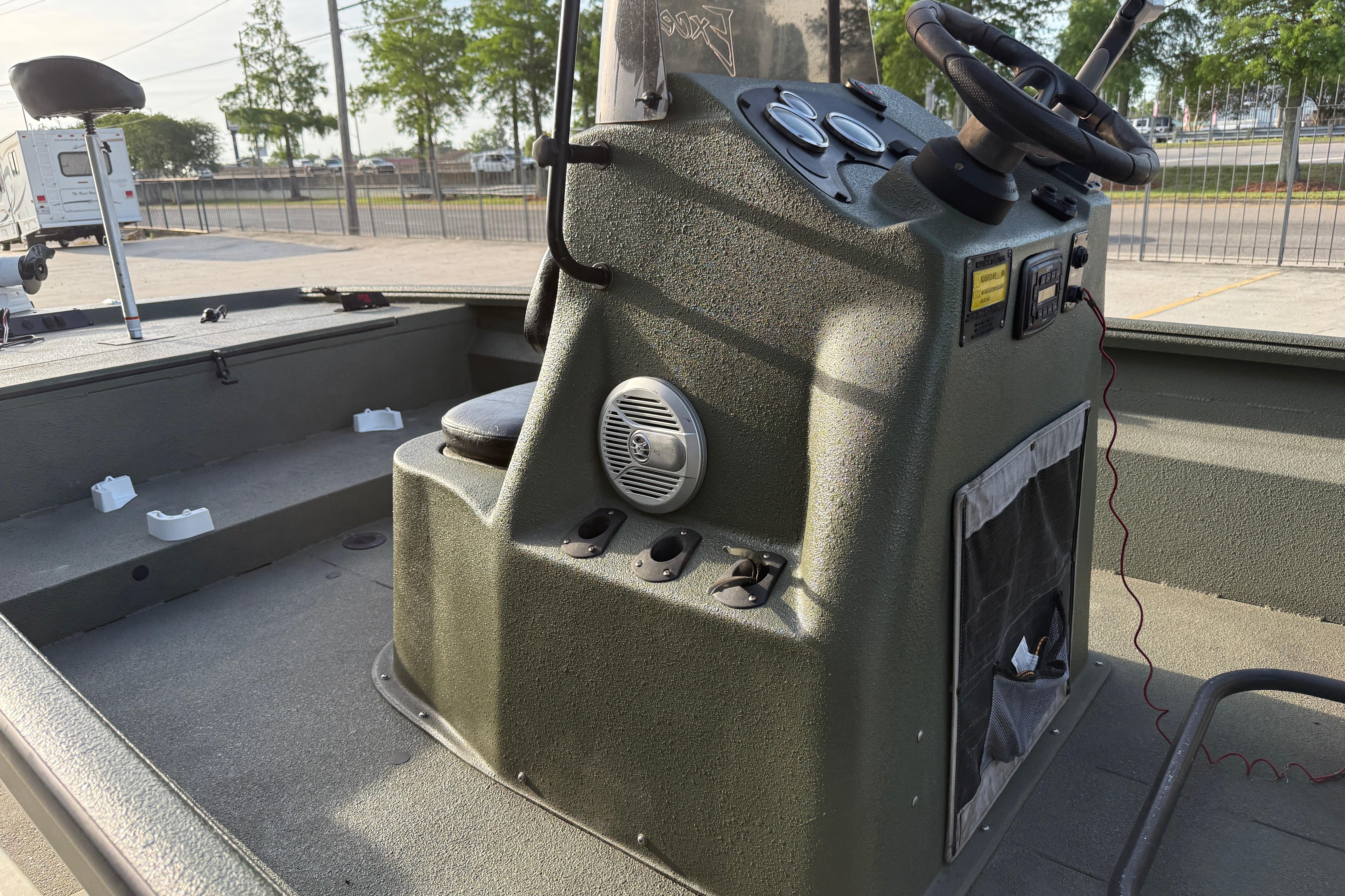 2014 Excel 203 Bay Pro boat console with steering wheel and controls.