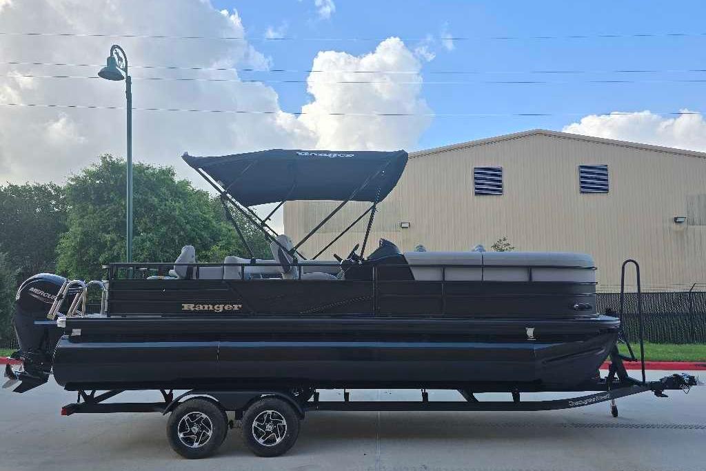 2026 Ranger 223FC pontoon boat on trailer, black exterior, parked outdoors.