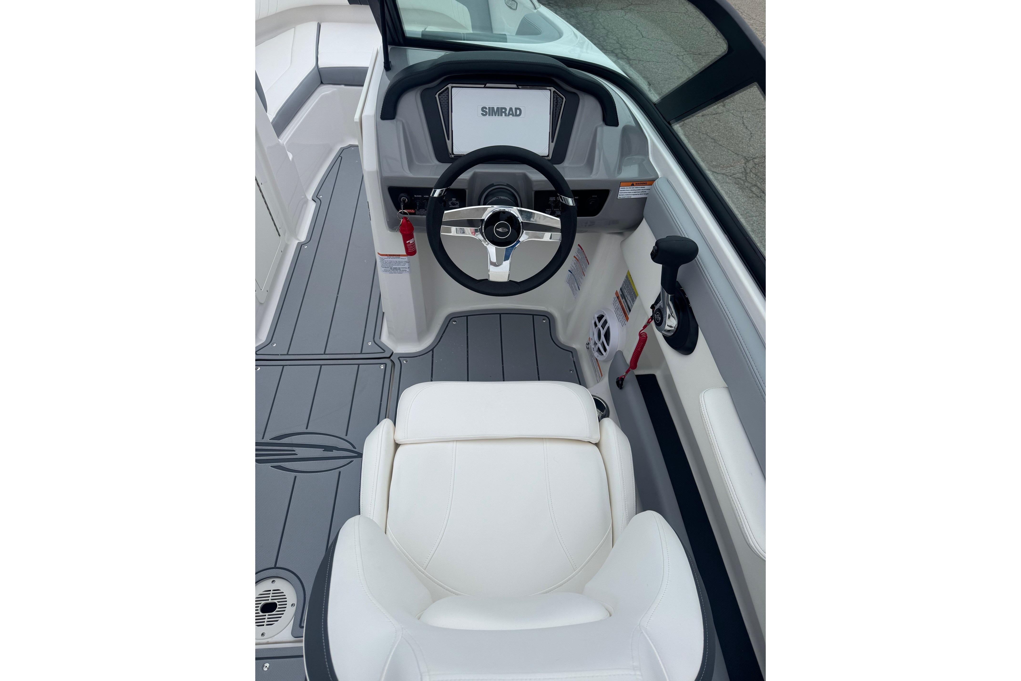 Interior view of 2026 Chaparral 21 SSi boat cockpit with steering wheel and controls.