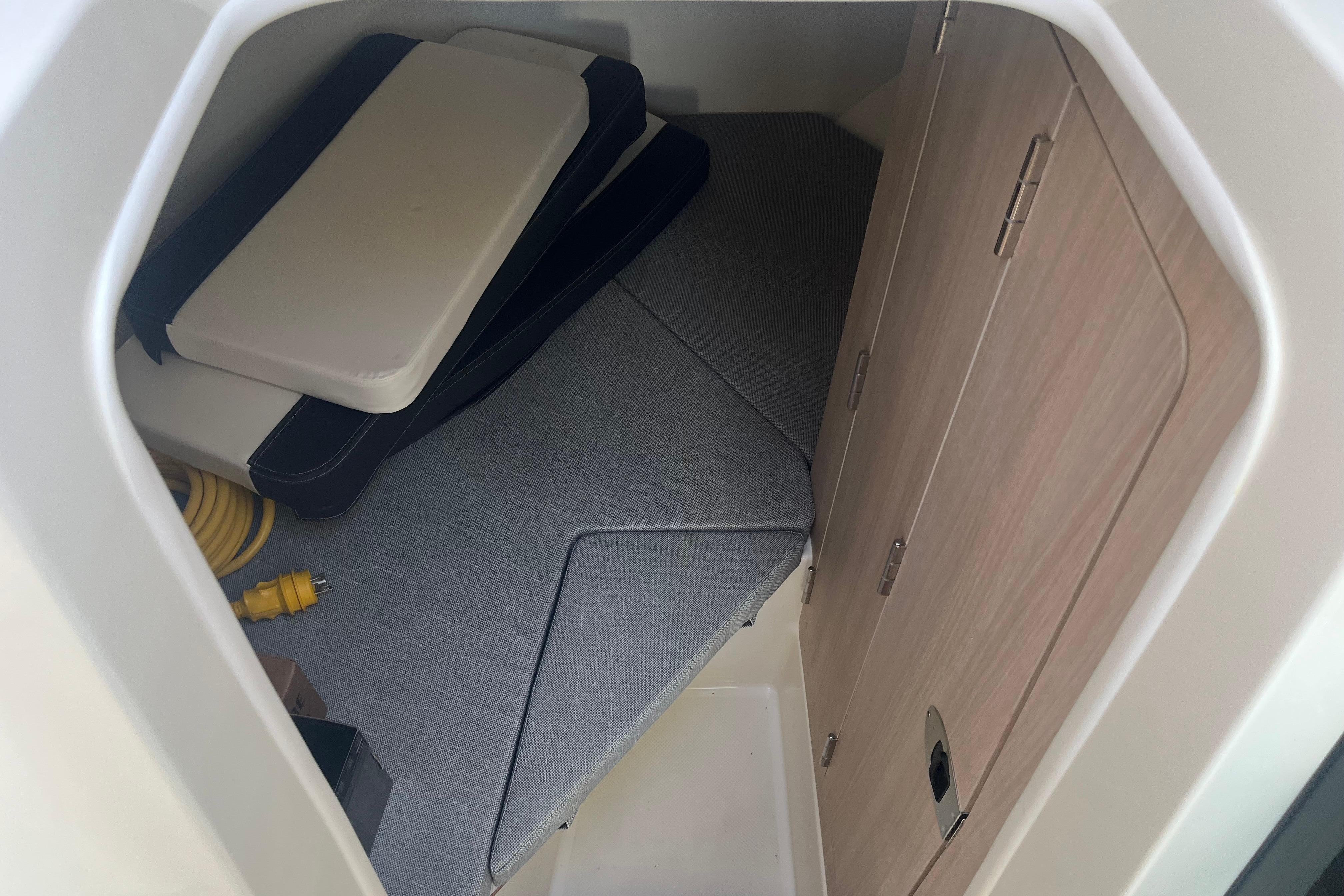 2025 Bayliner Trophy T25 Pilothouse cabin interior with cushions and storage space.