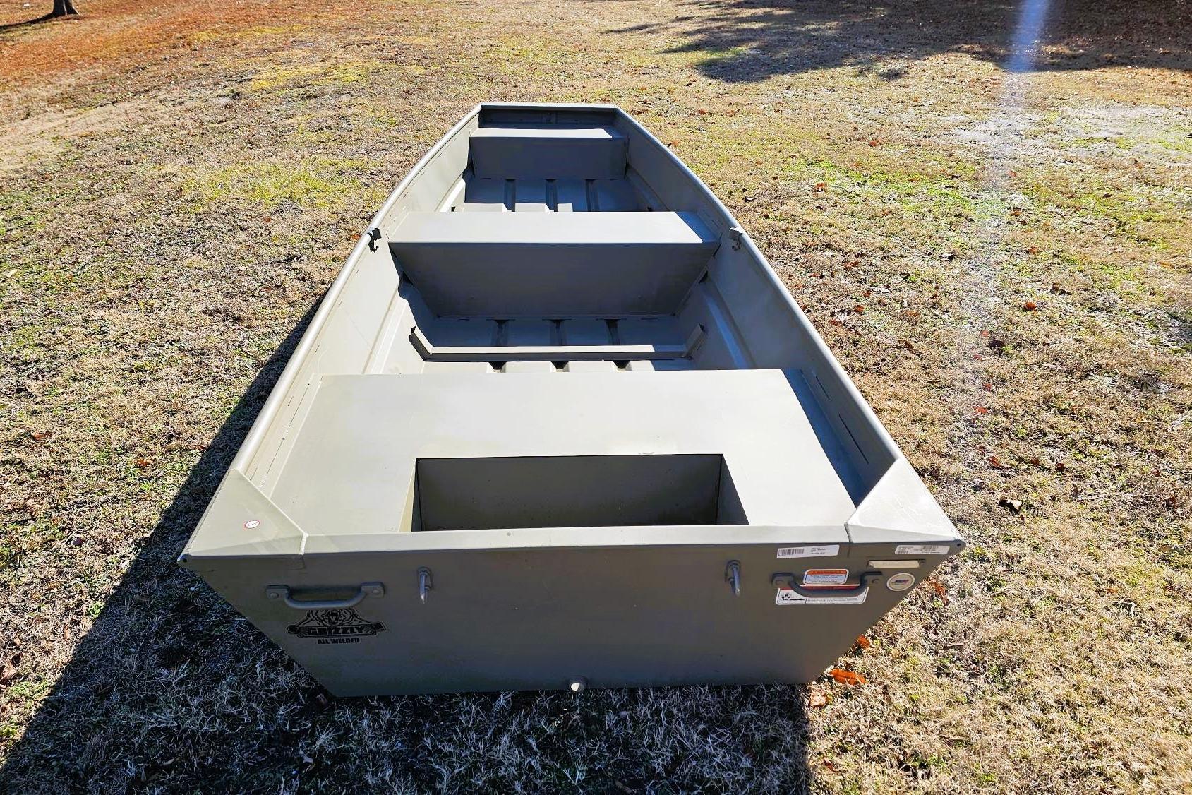 2026 Tracker Grizzly 14 Jon boat on grass, showcasing its sturdy aluminum build.