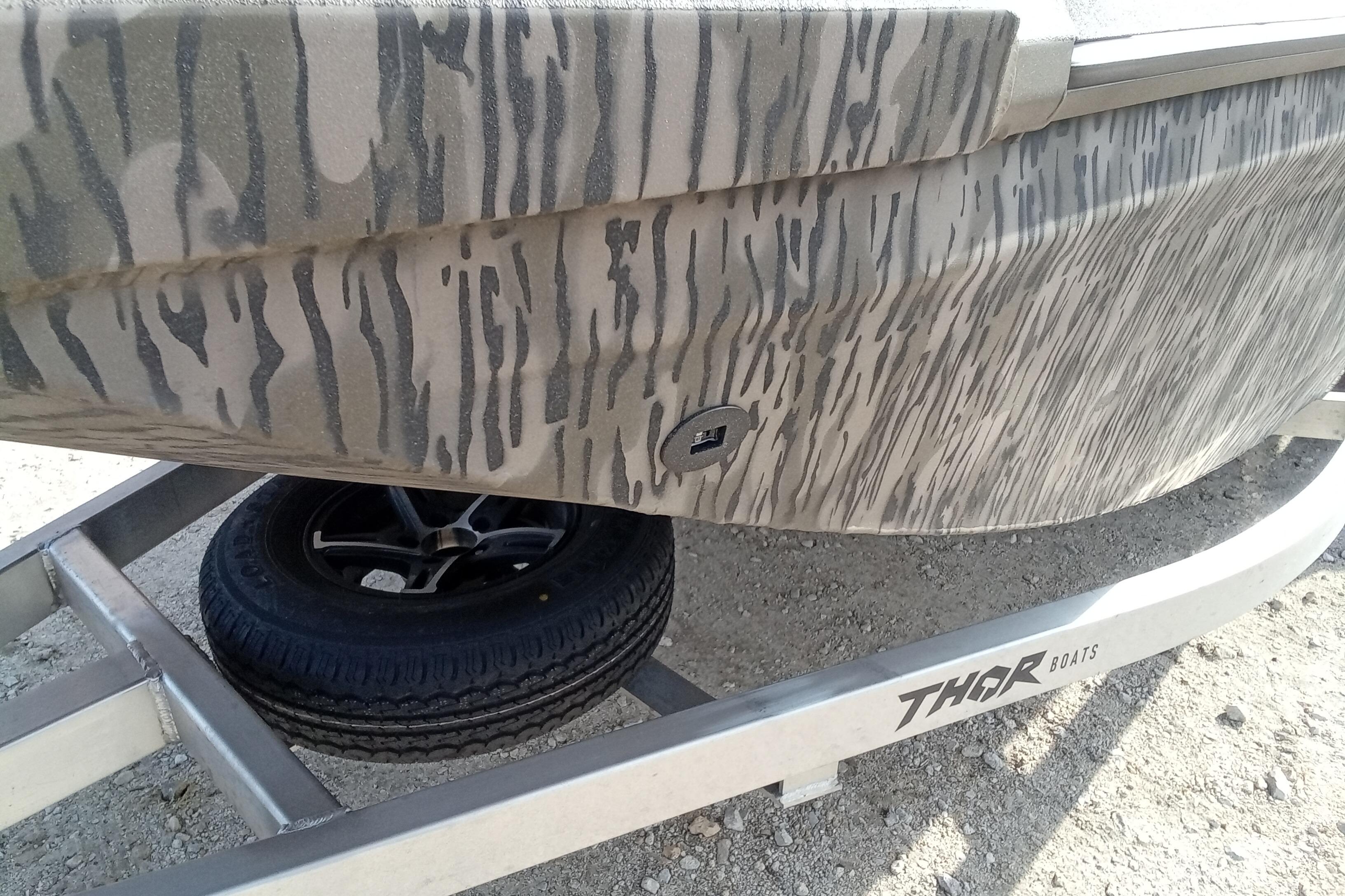 2026 Thor 1900 Low Country Elite boat with camouflage design on a trailer.