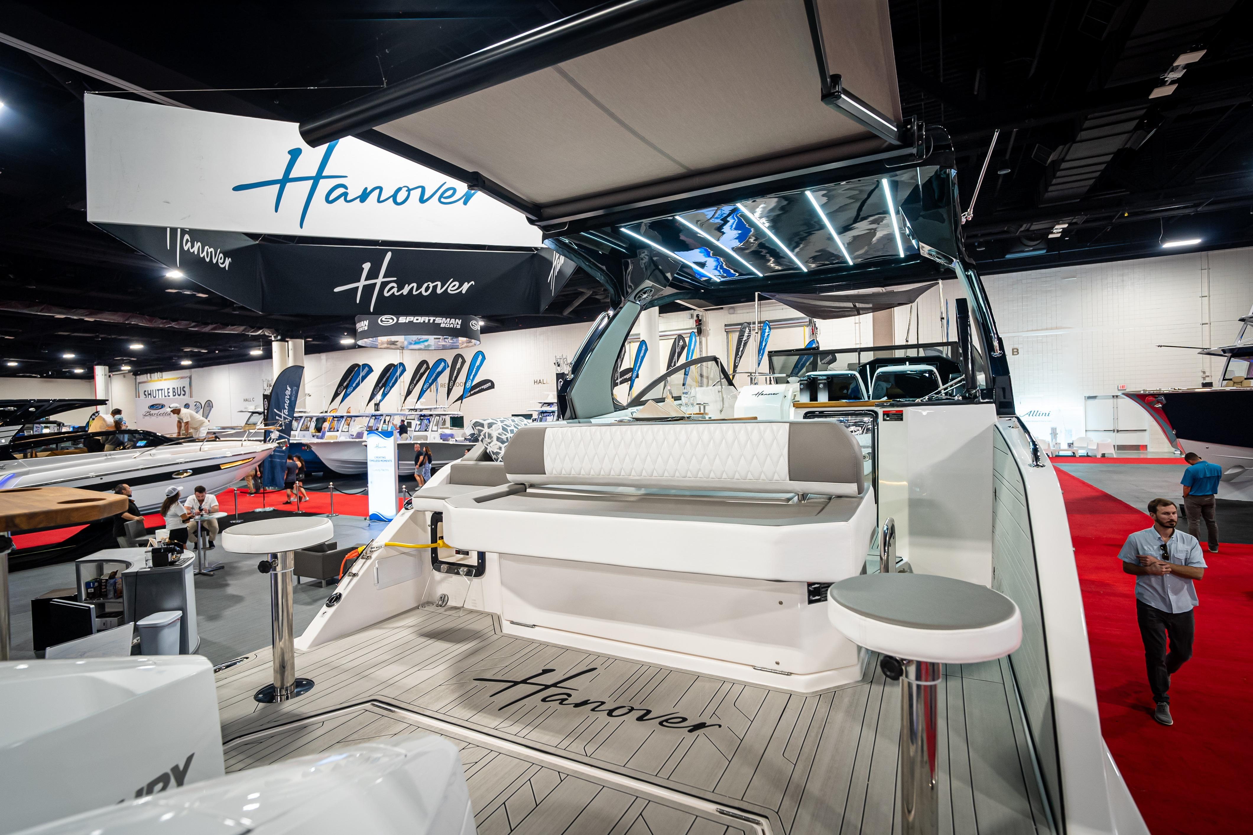 2026 Hanover 347 yacht displayed at a boat show, featuring sleek design and modern amenities.