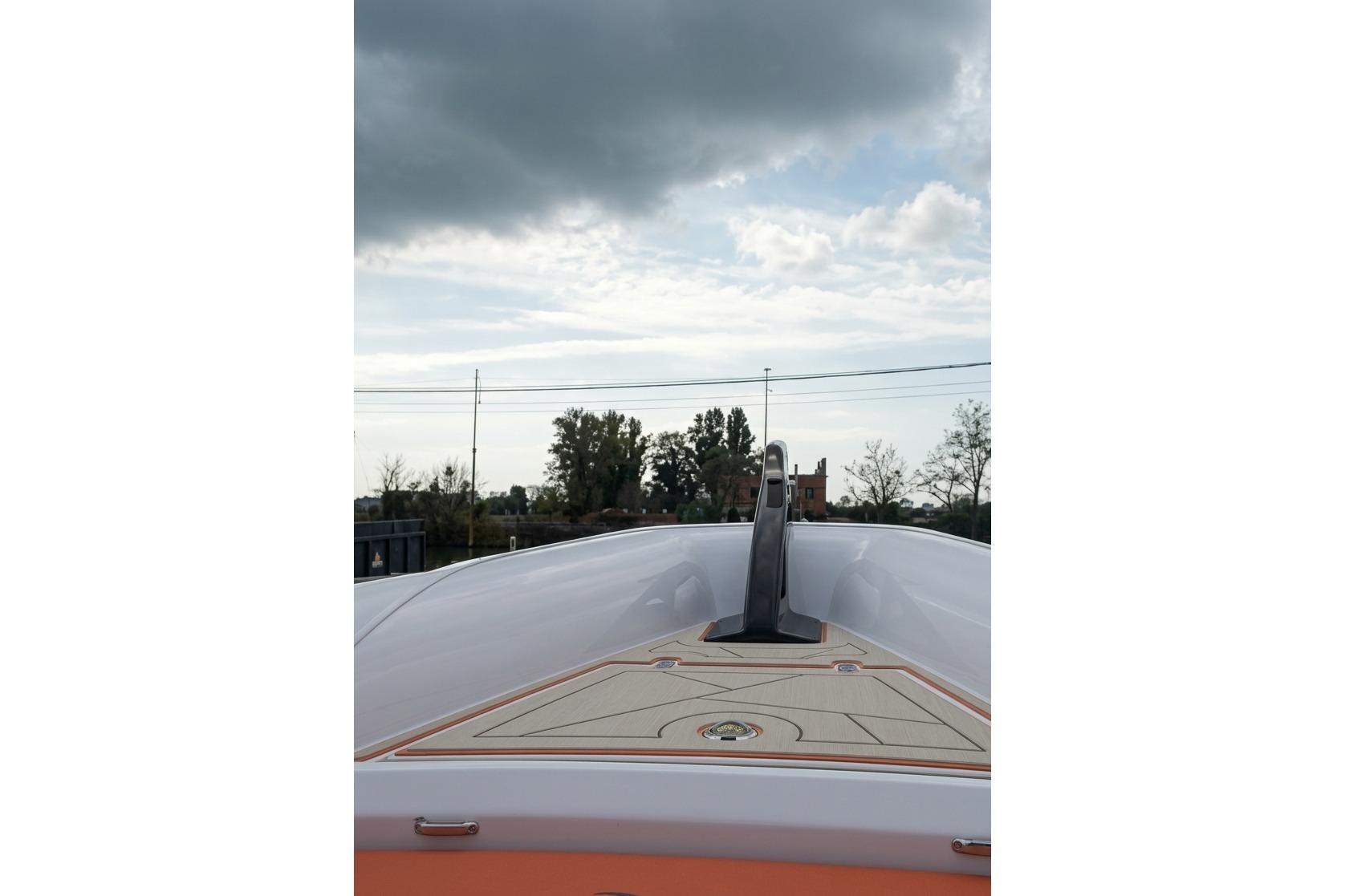 Bow view of 2025 Jolly Drive DNA 46 boat under cloudy sky.