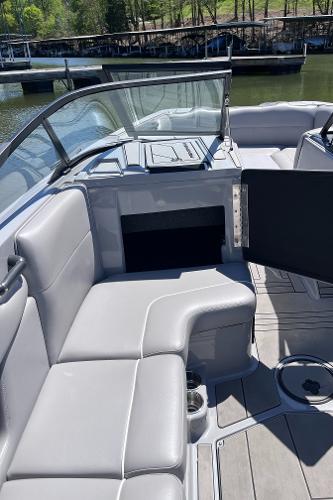 2024 Moomba Max boat interior with gray seating and open storage compartment.