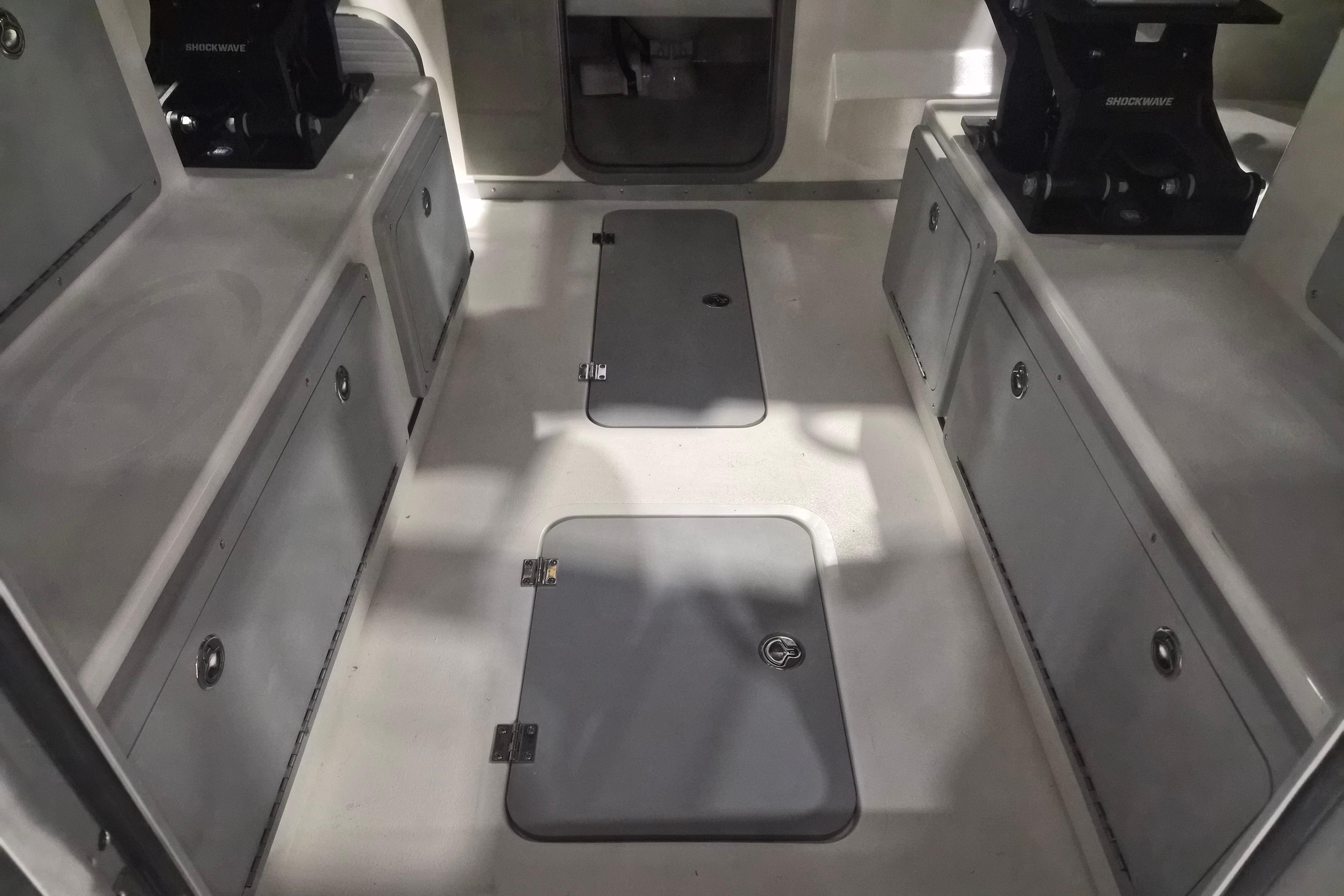 Interior view of 2026 Defiance Admiral 260 EX boat, showcasing storage compartments and seating.