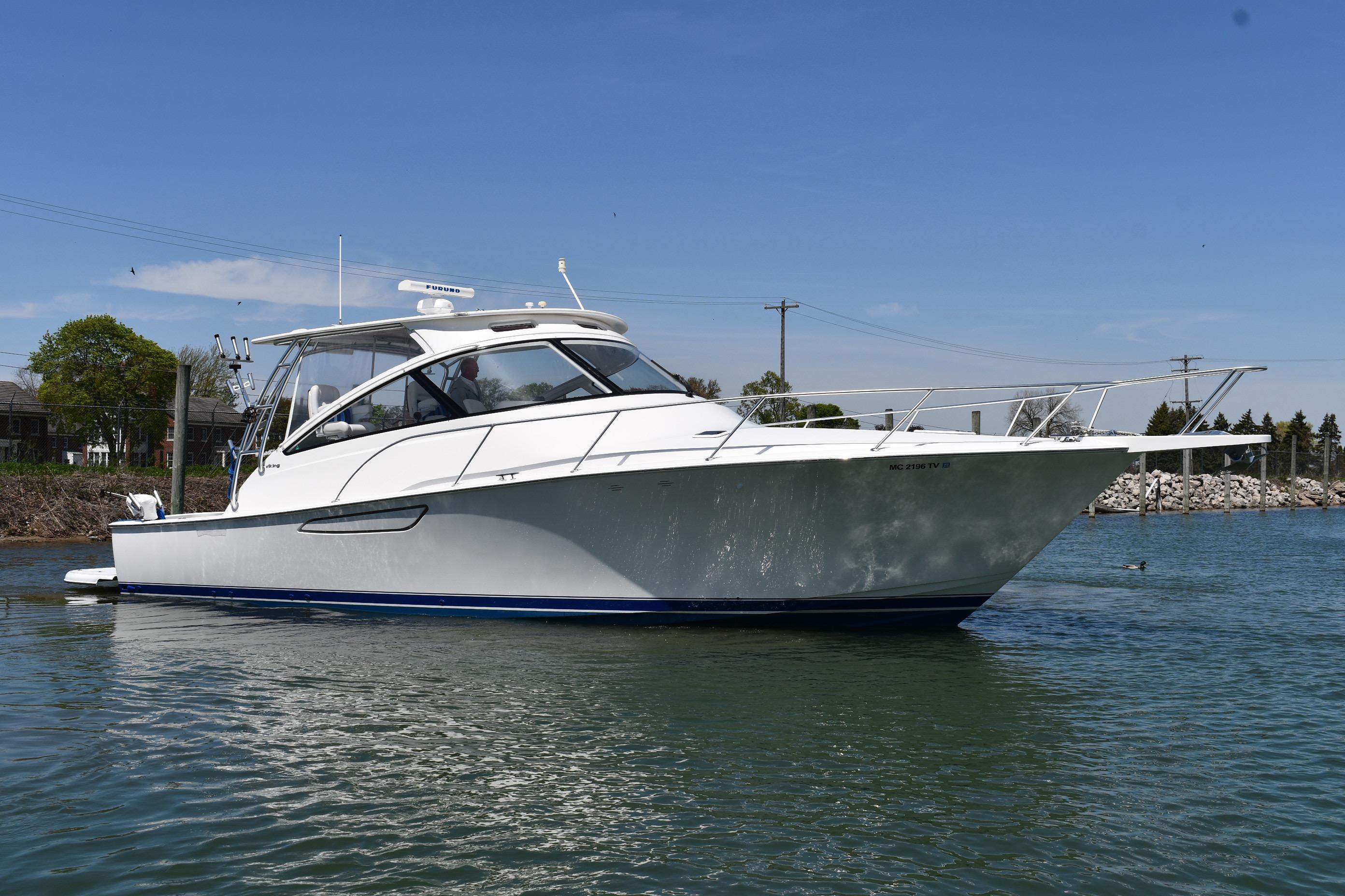 2012 Viking 42 Open yacht on calm water, showcasing sleek design and modern features.