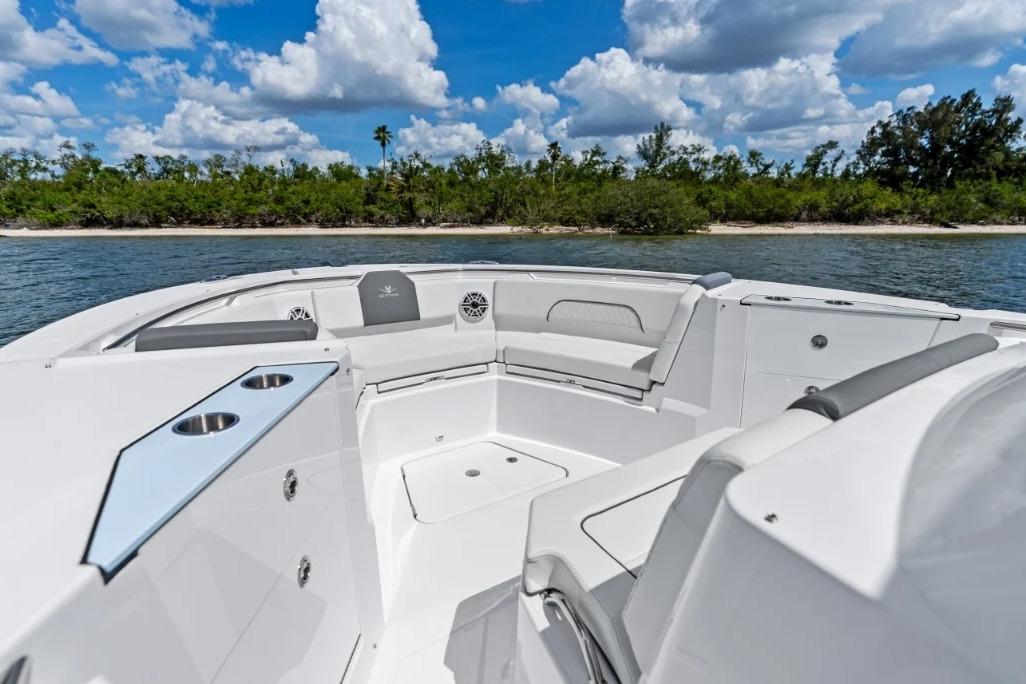 Manufacturer Provided Image: 2026 Bertram 34 CC boat interior with seating, cup holders, and scenic water view.