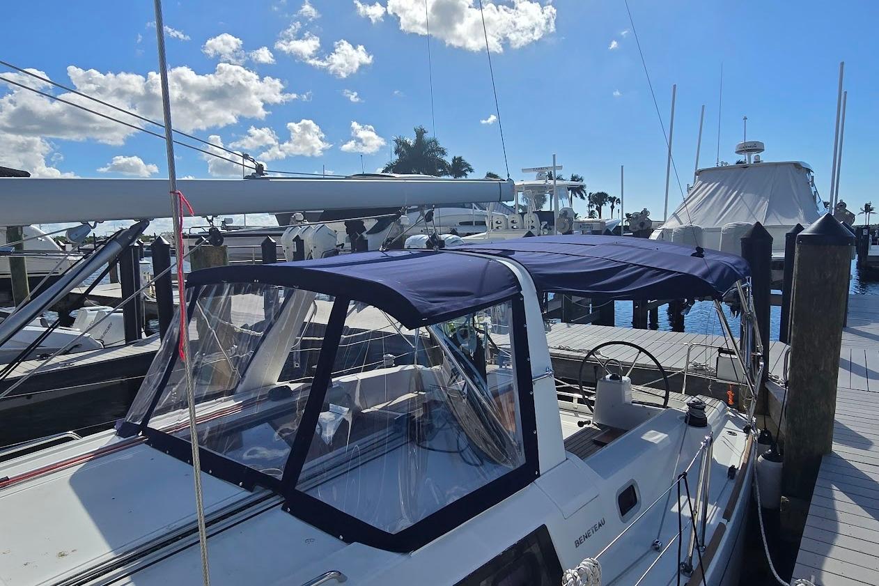 2023 Beneteau Oceanis 38.1 sailboat docked at marina under clear blue sky.