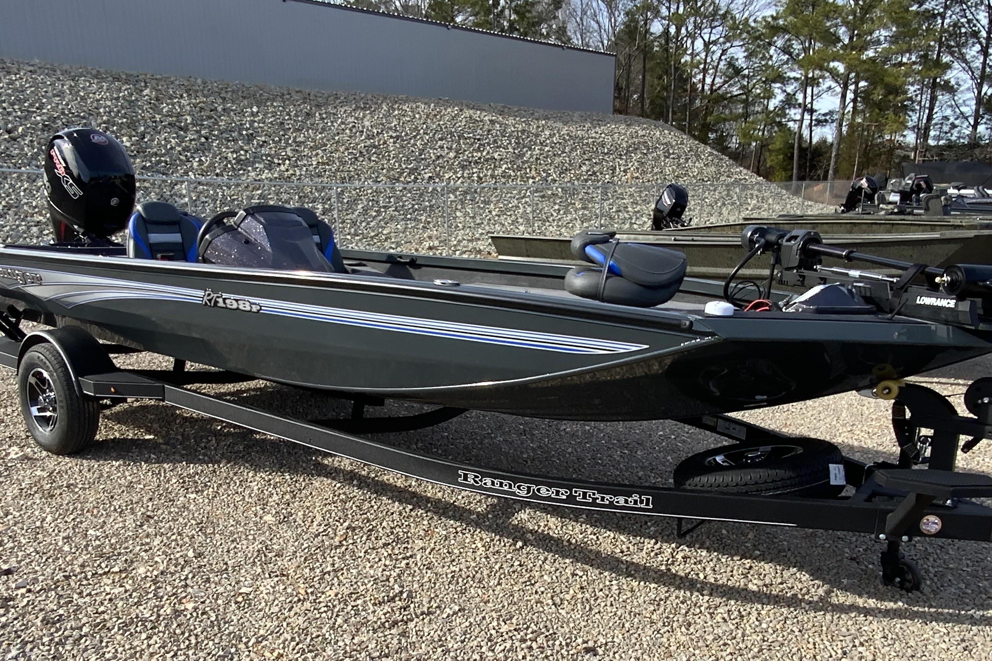 2026 Ranger RT198P fishing boat on trailer, parked on gravel lot.