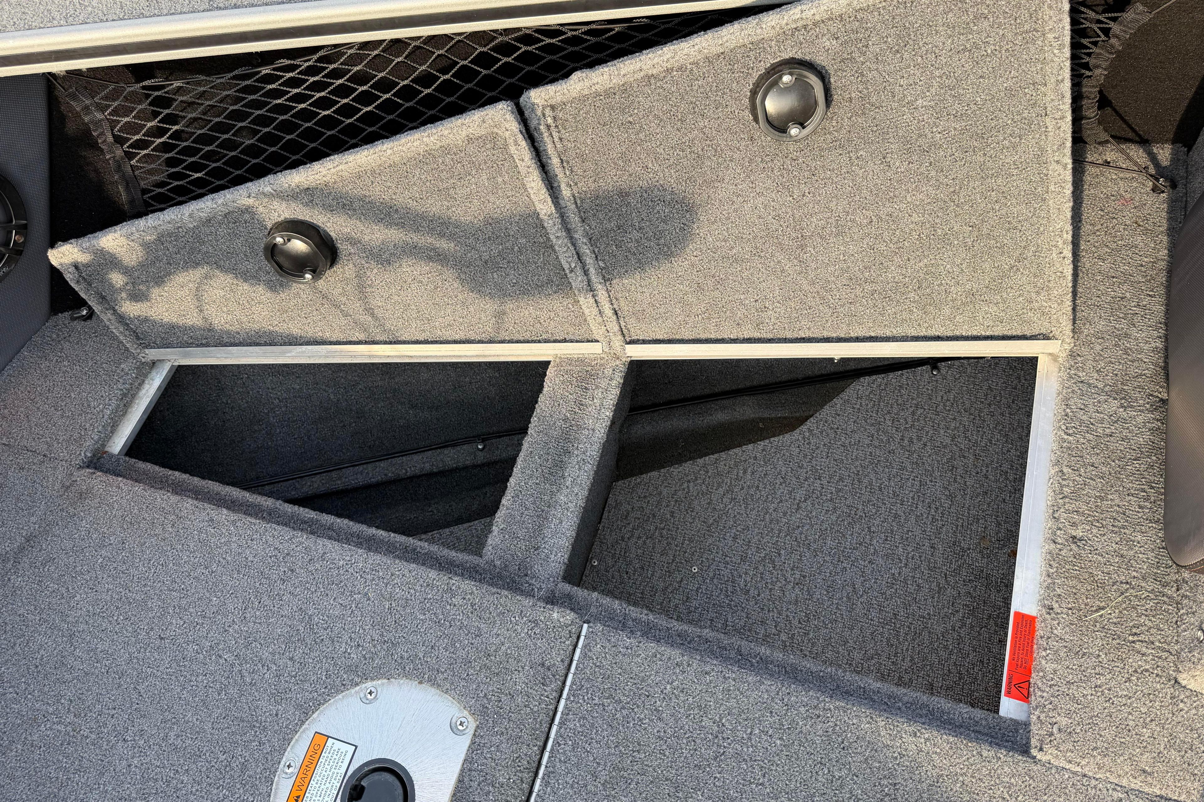 2019 Alumacraft Trophy 205 boat storage compartments with carpeted interior and secure latches.