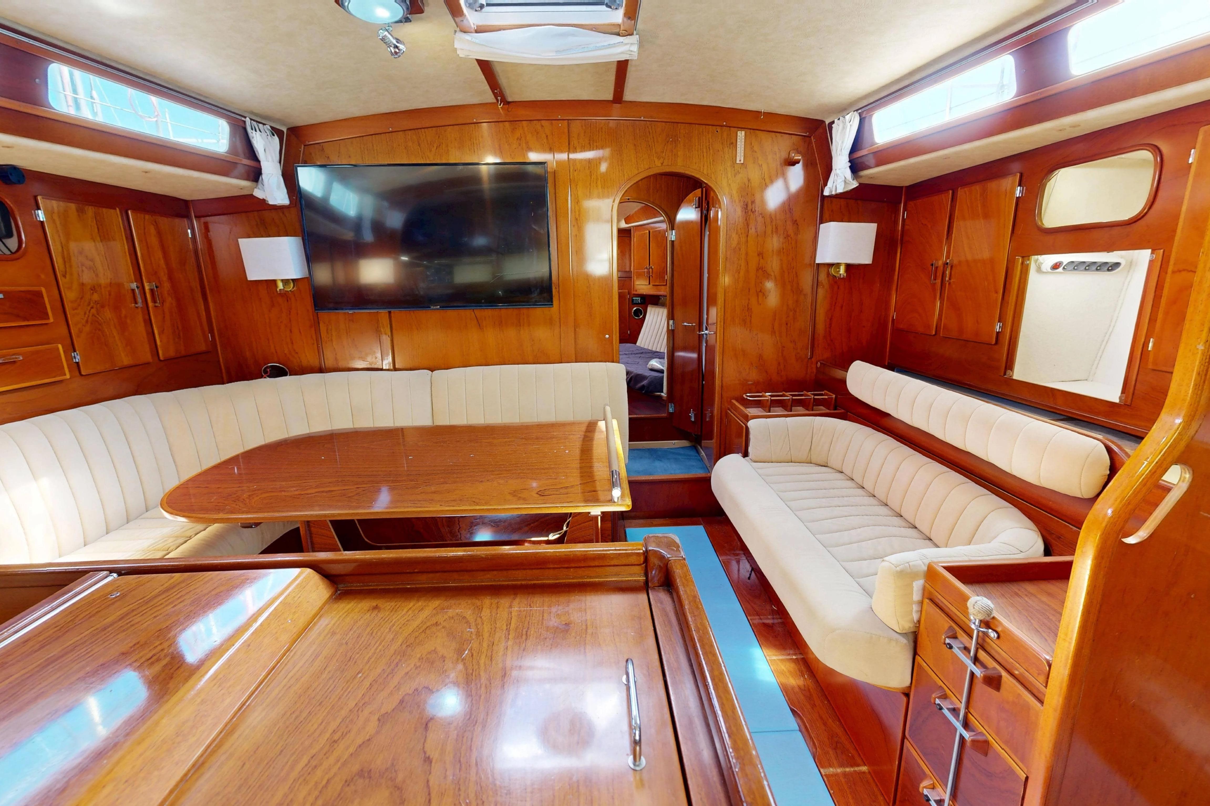 Luxurious interior of 1999 Amel Super Maramu 2000 yacht with elegant wood finish.