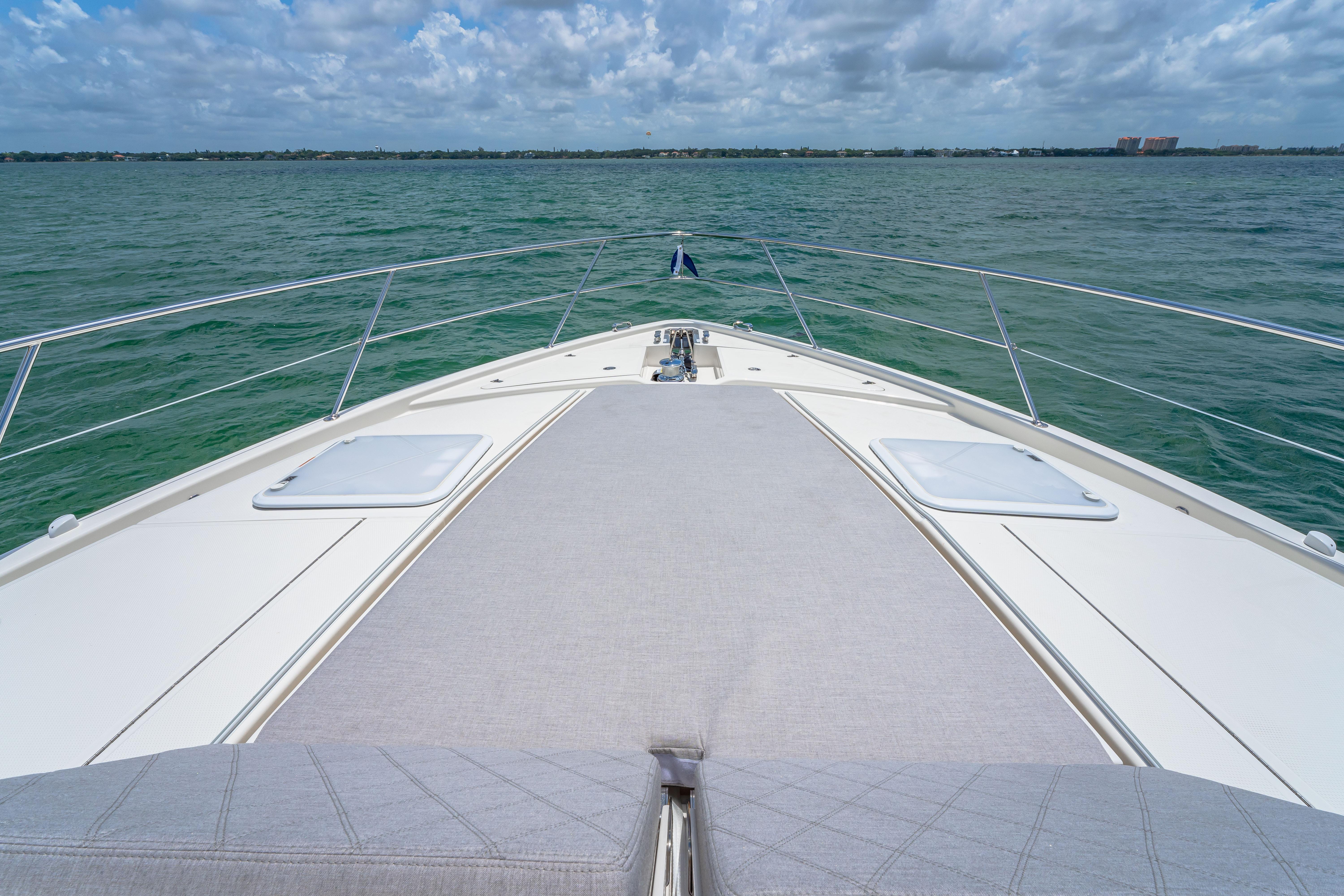 Bow view of 2024 Riviera 505 SUV yacht on open water.
