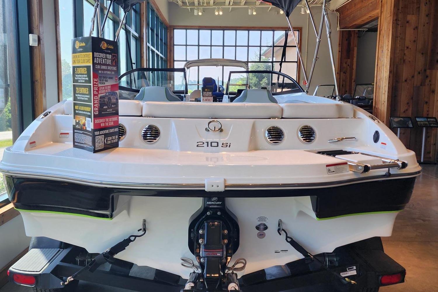 2024 Tahoe 210 Si boat displayed indoors, showcasing rear design and features.