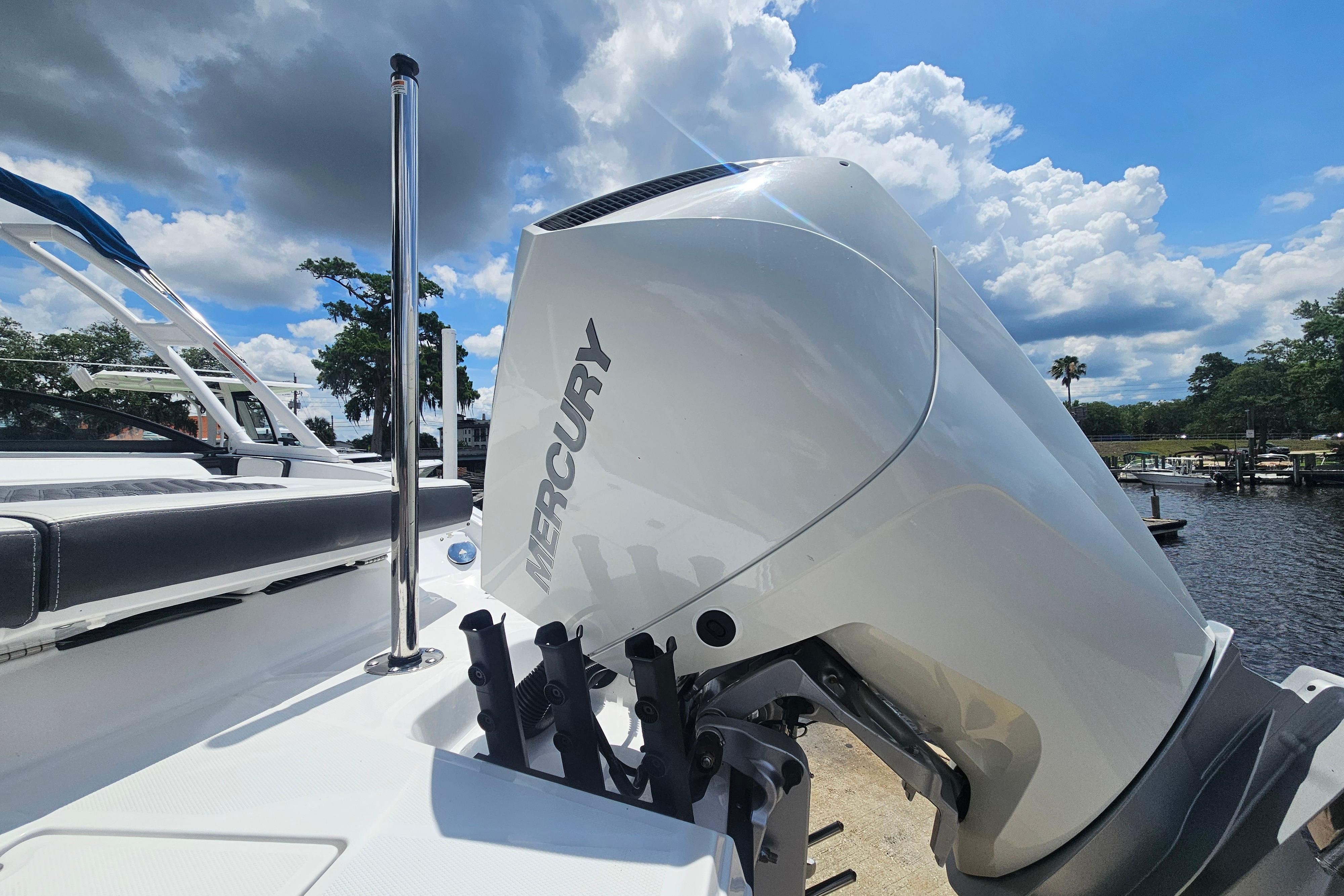 2024 Monterey 215SS Super Sport boat with Mercury engine, docked under a cloudy sky.
