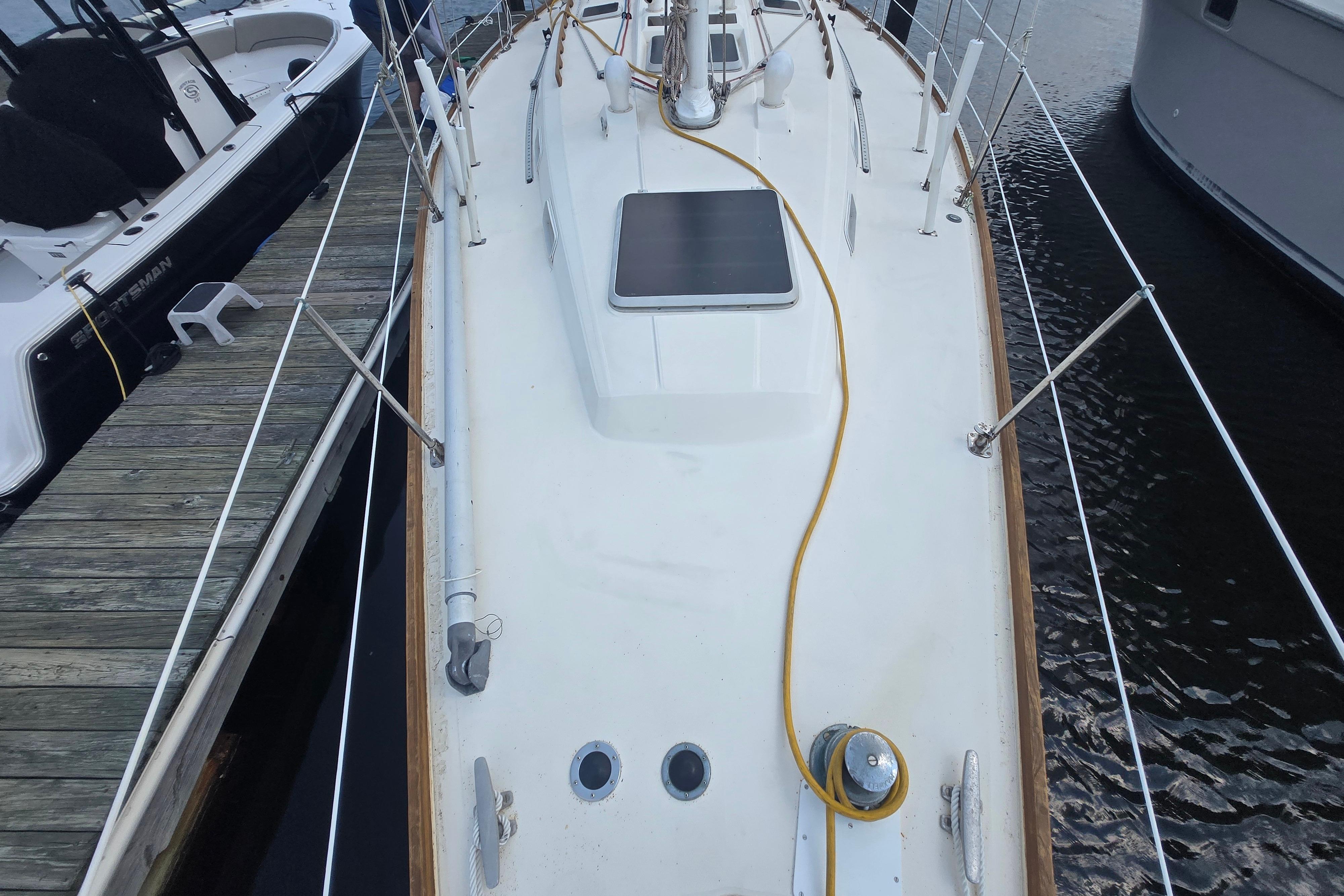 1988 Sabre 38 sailboat deck view, docked with yellow power cable.