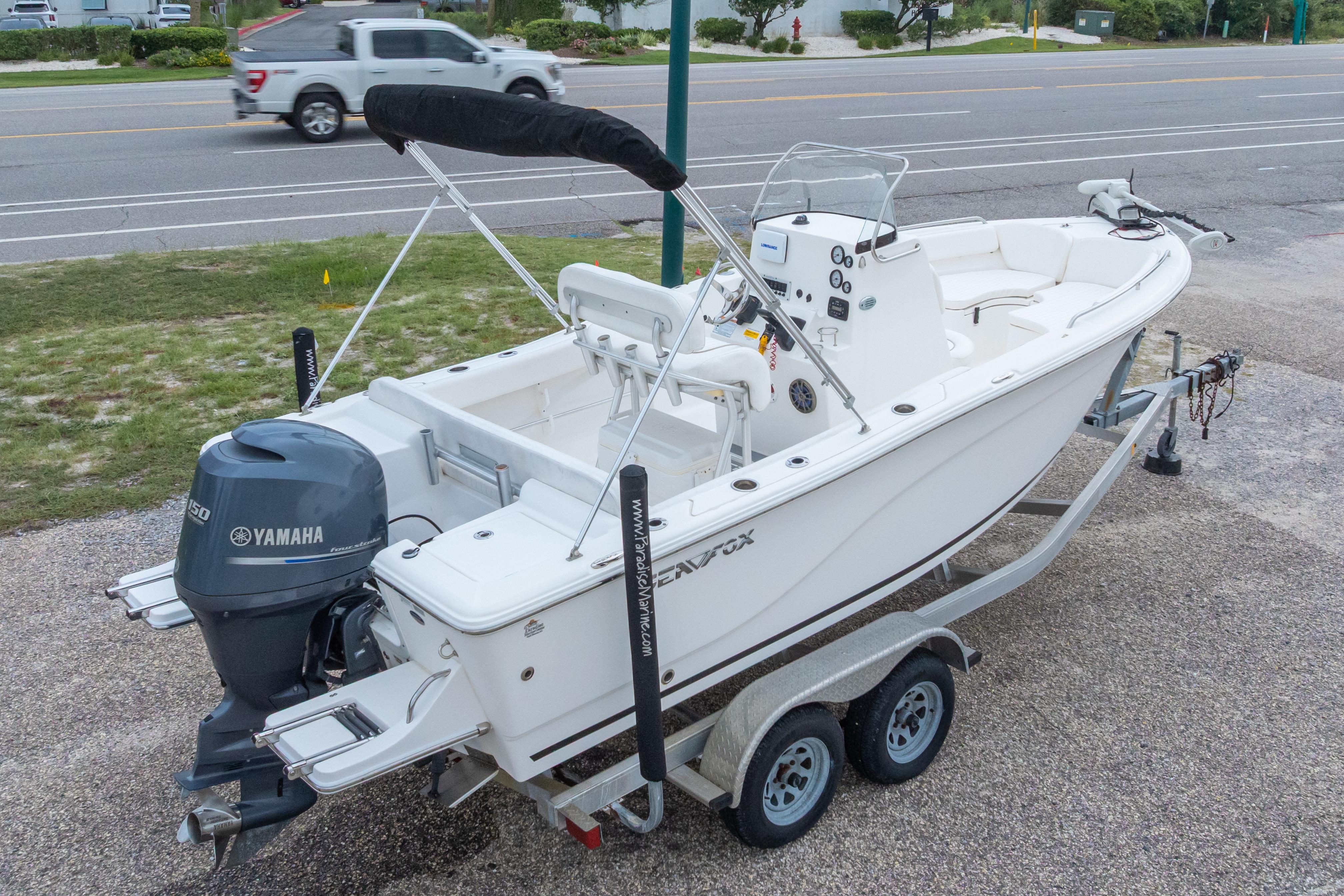 2014 Sea Fox 209 Commander boat on trailer with Yamaha outboard motor, parked near road.