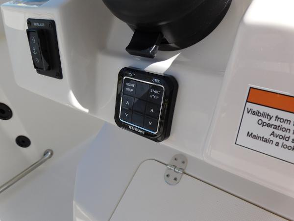 Control panel of 2024 Sailfish 242 CC boat with Suzuki start/stop buttons.