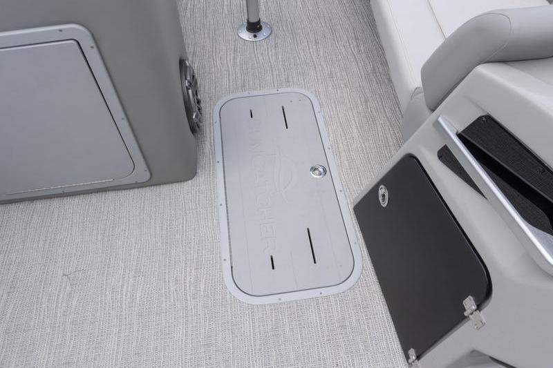 Interior view of 2026 SunCatcher Elite 326 SS boat, featuring sleek flooring and storage compartments.