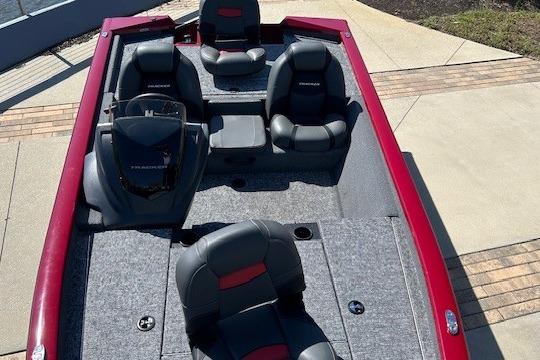 2026 Tracker Pro Team 175 boat with red and gray interior, docked on concrete.