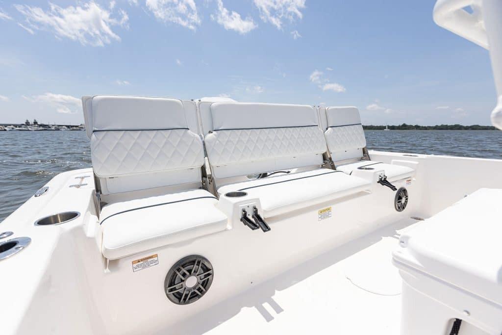 2027 Sea Fox 231 Bay Fox boat interior with white cushioned seating and water view.