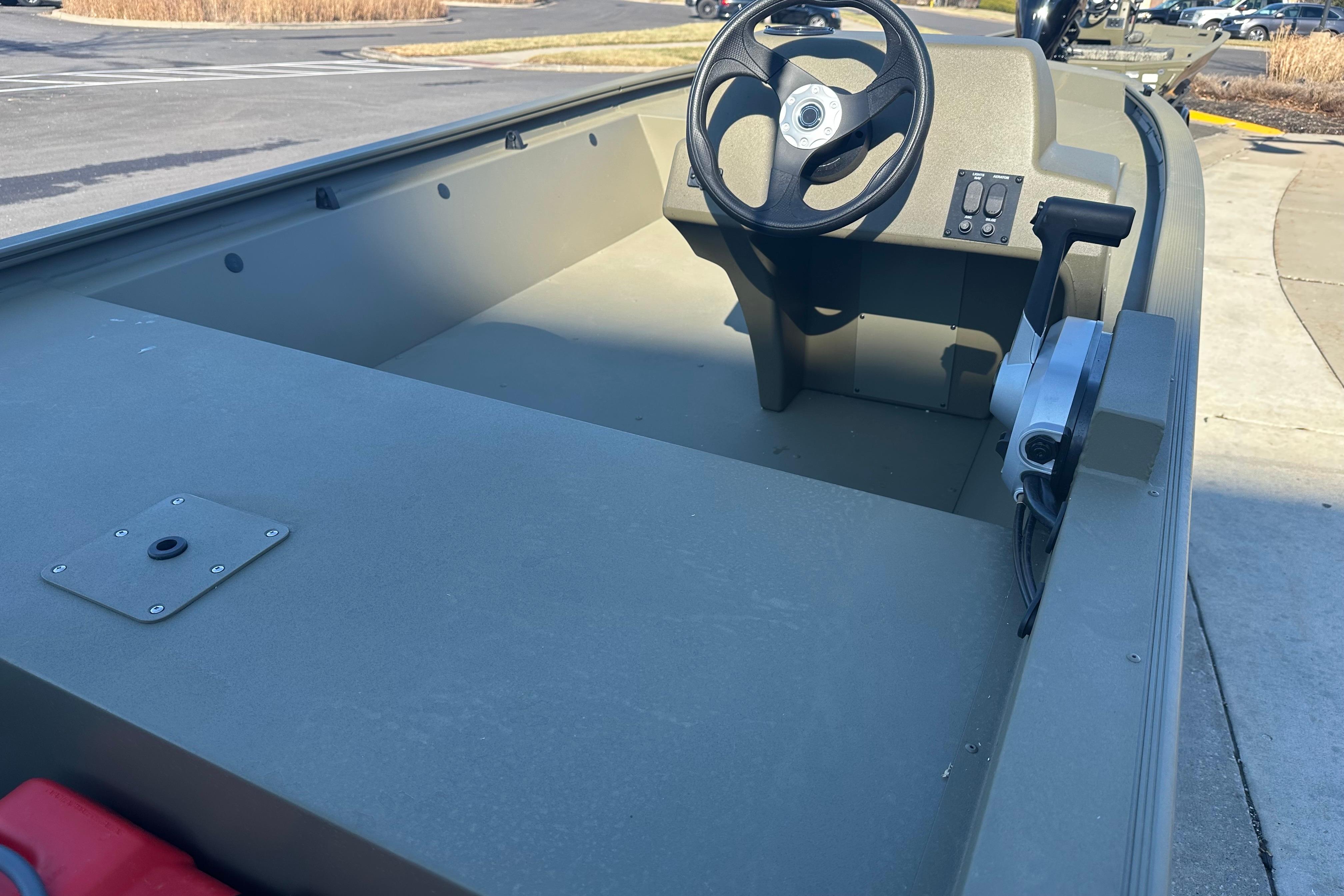 2026 Tracker Grizzly 1648 SC boat interior with steering wheel and control panel.