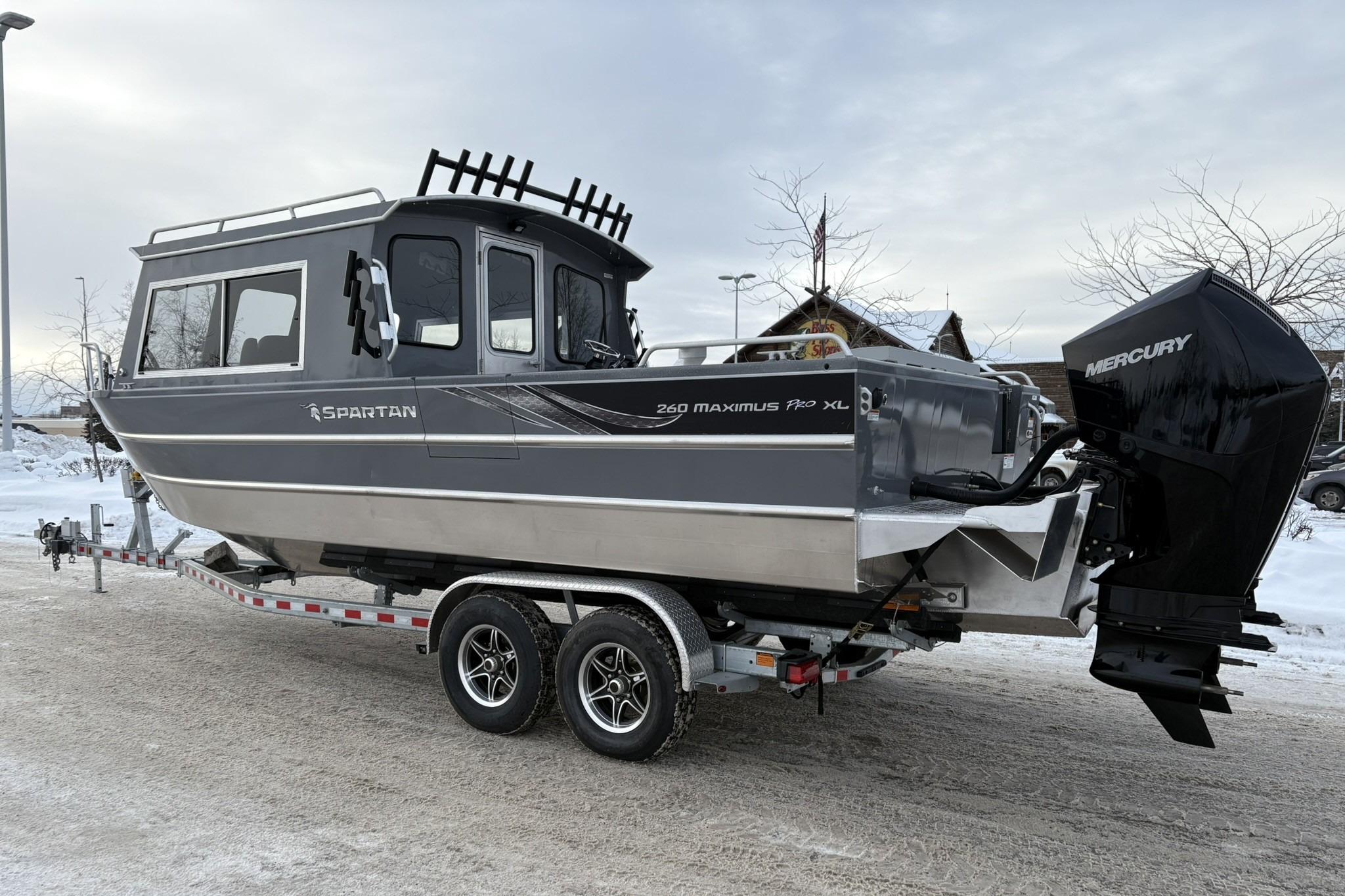 2024 Spartan 26 Maximus Pro XL boat on trailer, snowy background, Mercury engine.