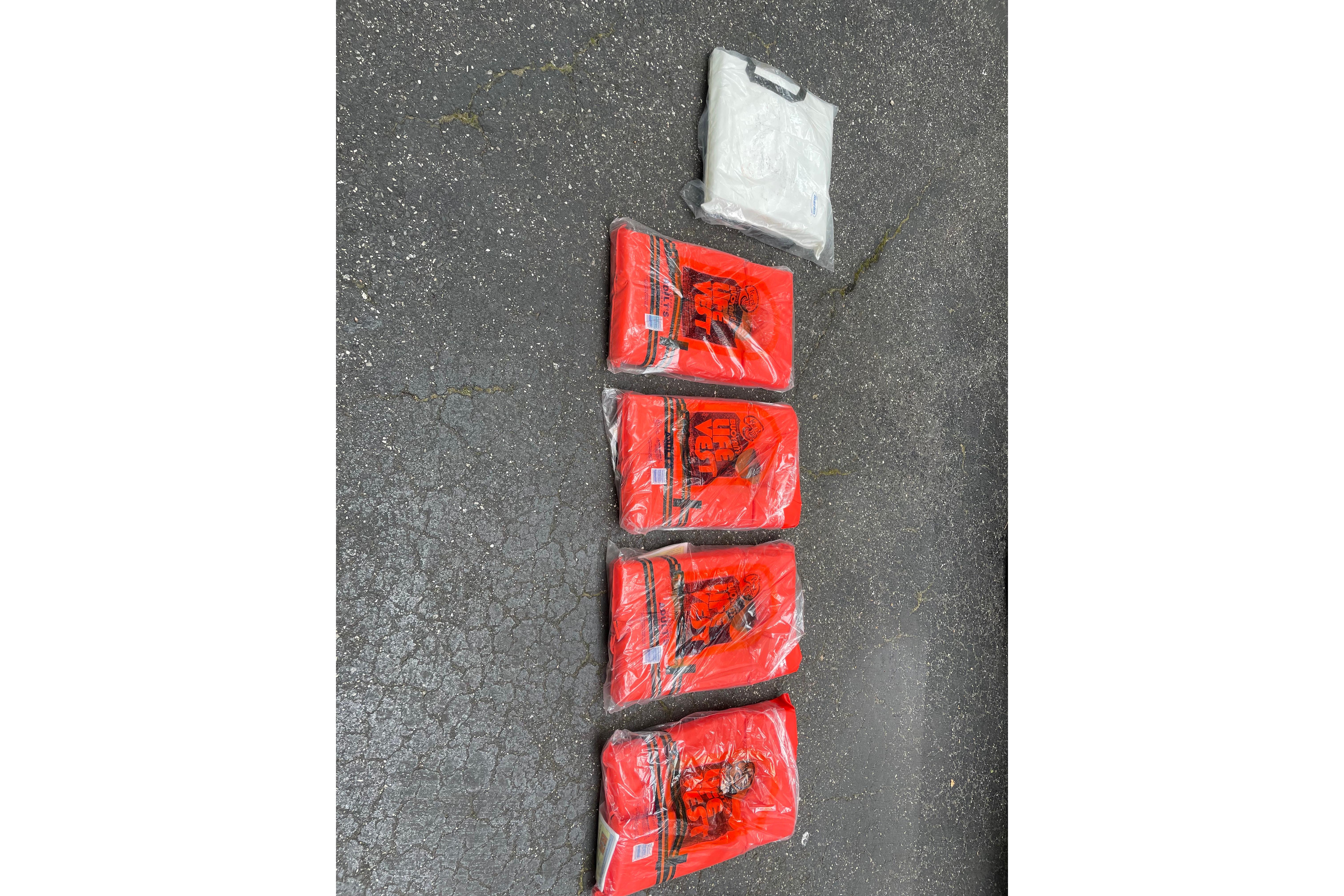 Five packaged red life jackets on pavement, suitable for Sea Hunt Victory 207, 2008 model.