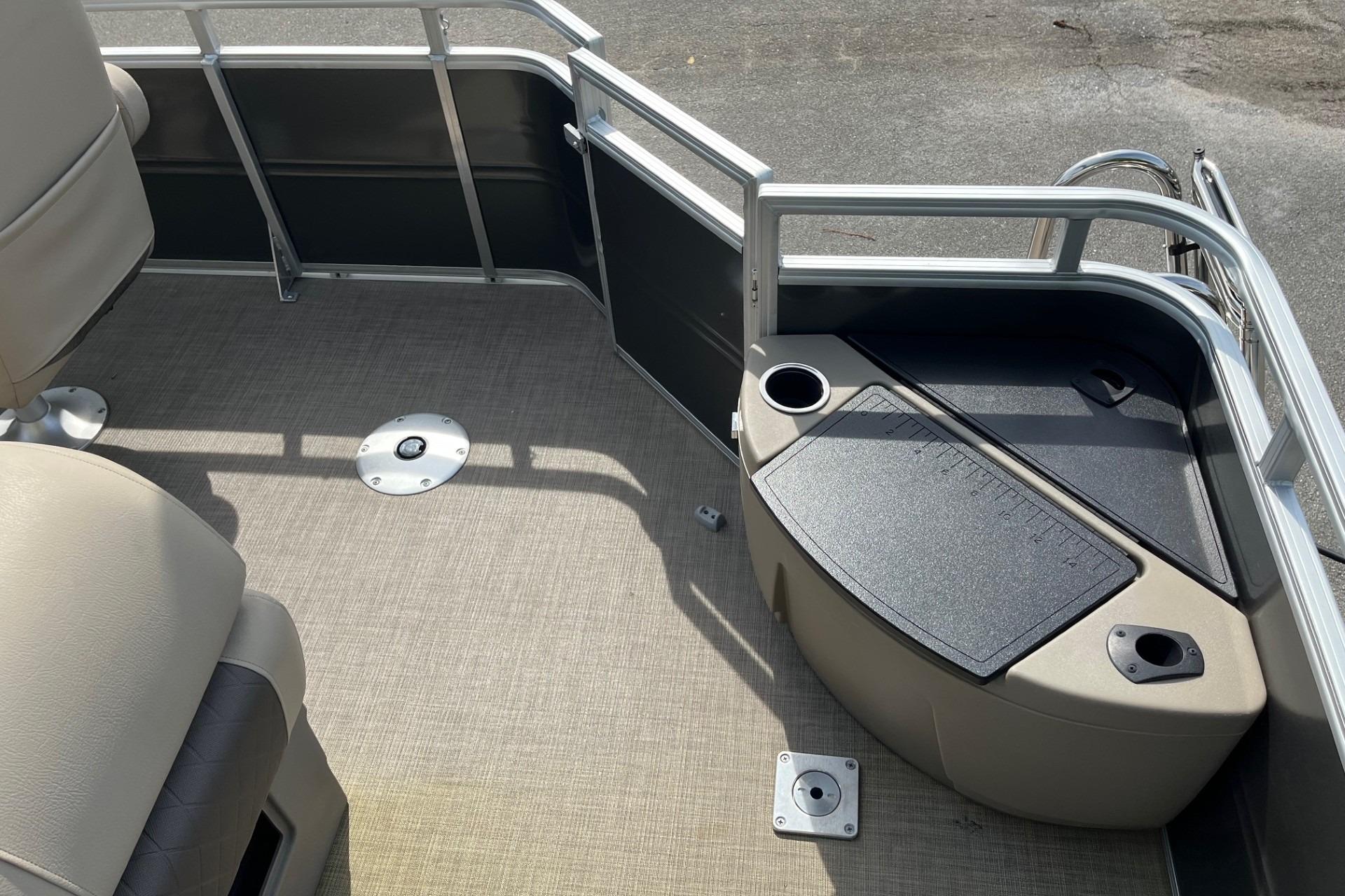 2025 Sun Tracker Fishin' Barge 20 DLX interior with seating and storage compartments.