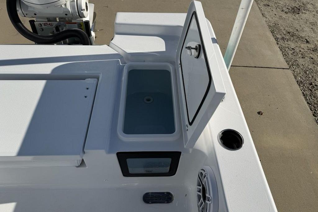 2026 Sportsman Masters 247OE Bay Boat with open storage compartment and speaker.
