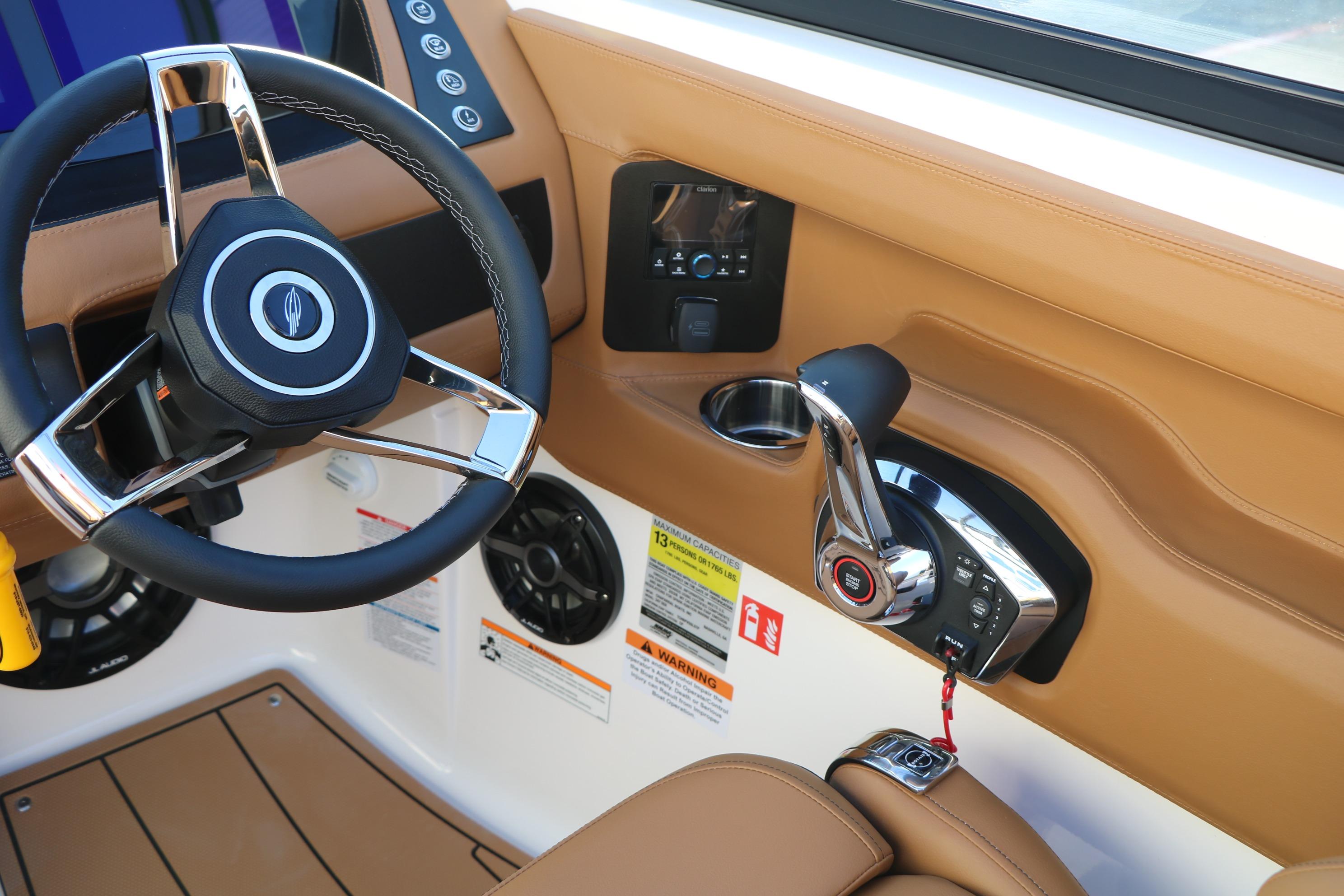 2026 Chaparral 247 SSX boat cockpit with steering wheel and throttle controls.