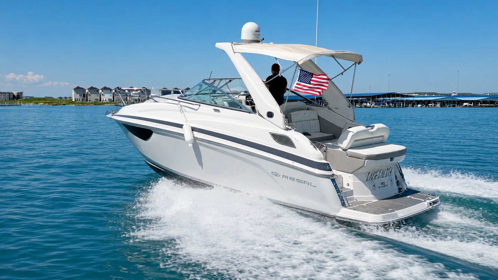 2020 Regal 28 Express on the water with an American flag.