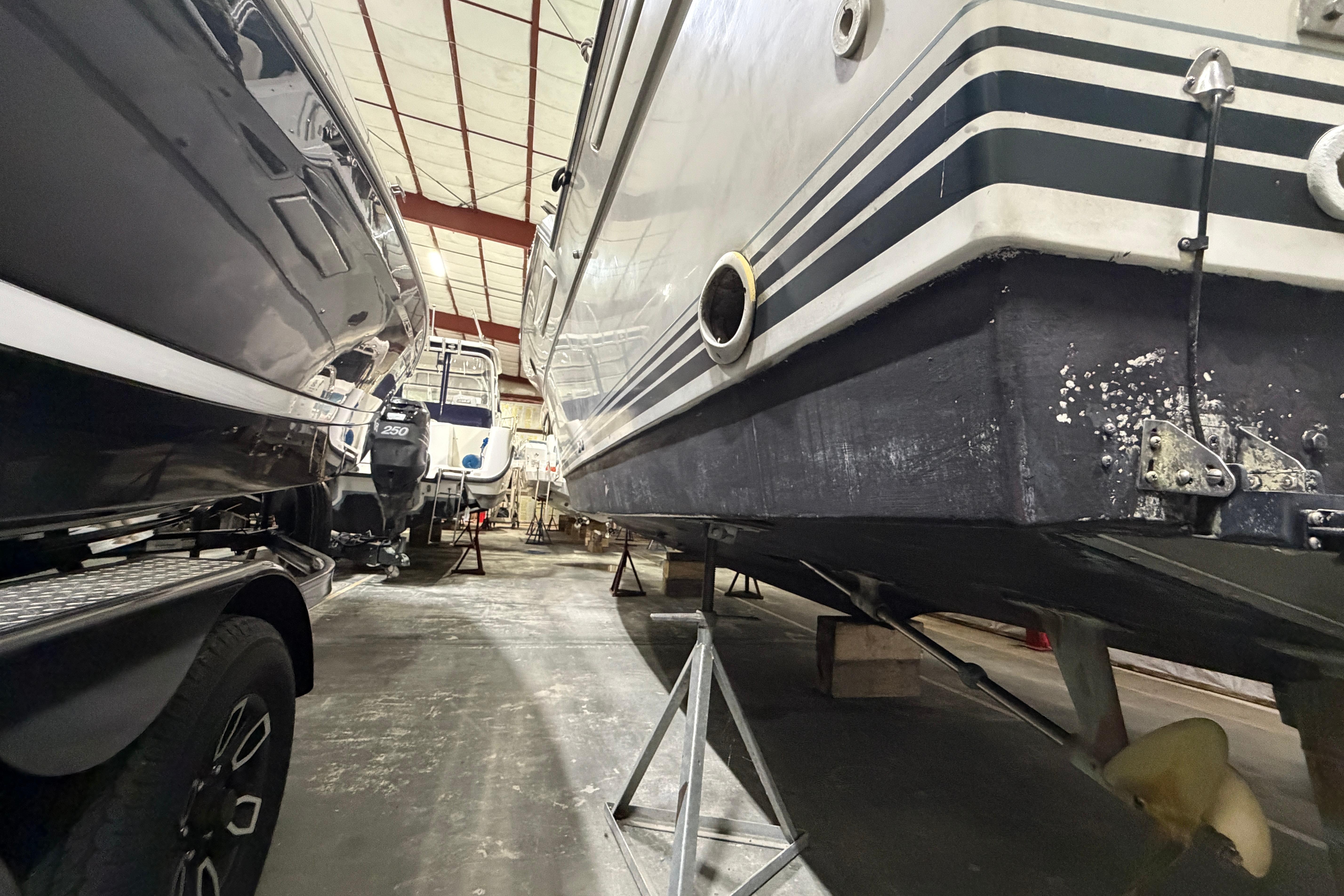 1989 Tiara Yachts 3600 Open in storage, showcasing hull and propeller details.
