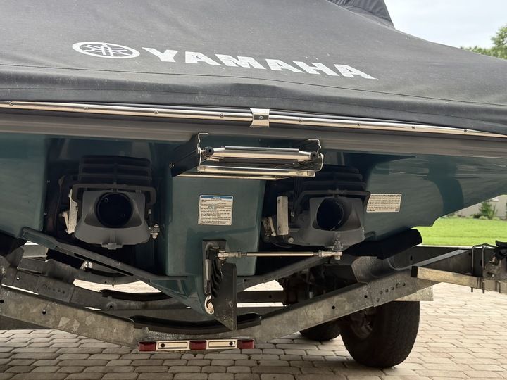 Rear view of a Yamaha 212SD boat on a trailer, with cover and jet drives.