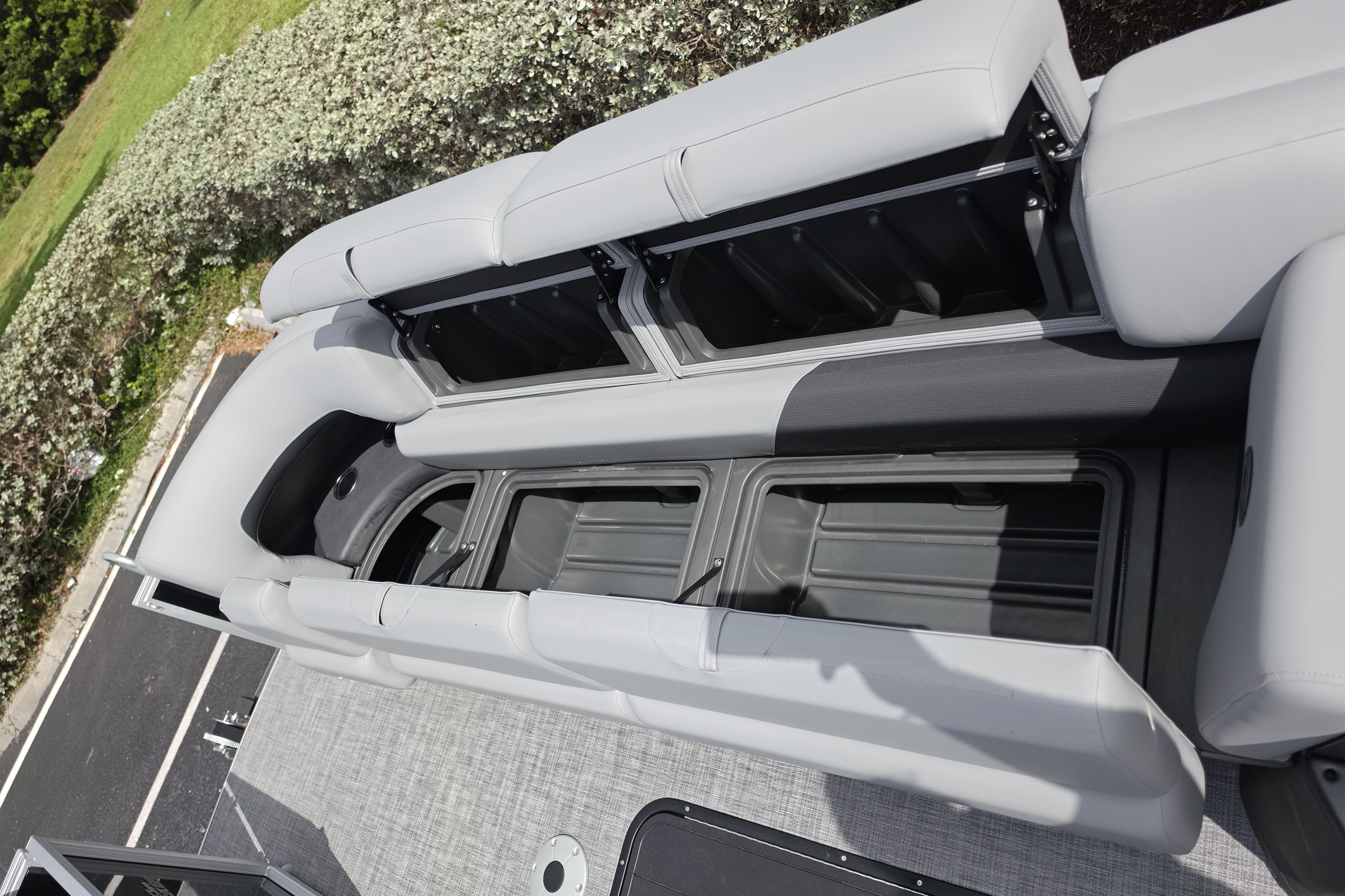 2026 Sun Tracker Party Barge 24 XP3 interior seating with open storage compartments.
