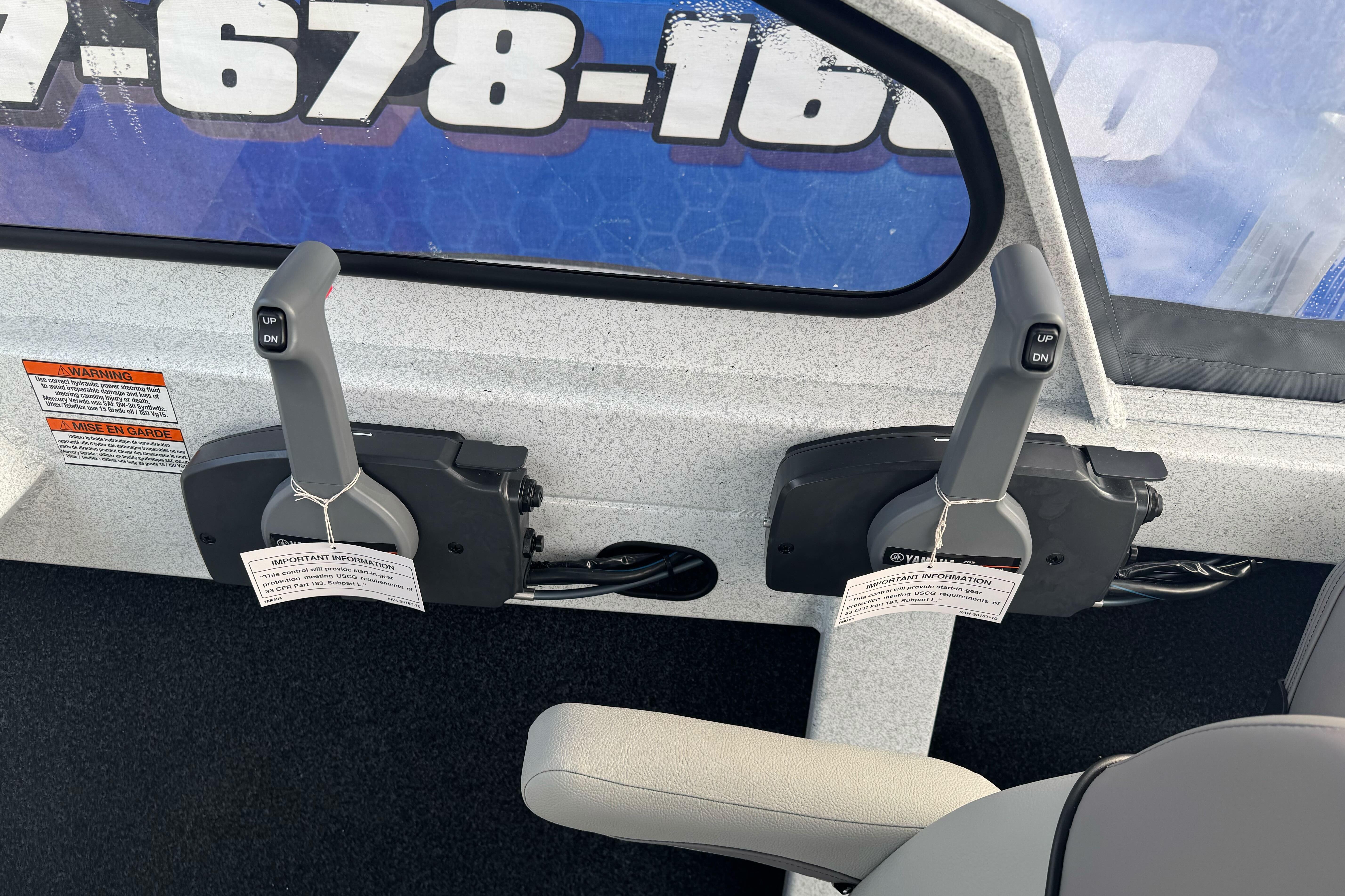 Dual throttle controls in a 2026 KingFisher 2025 Escape boat cockpit.